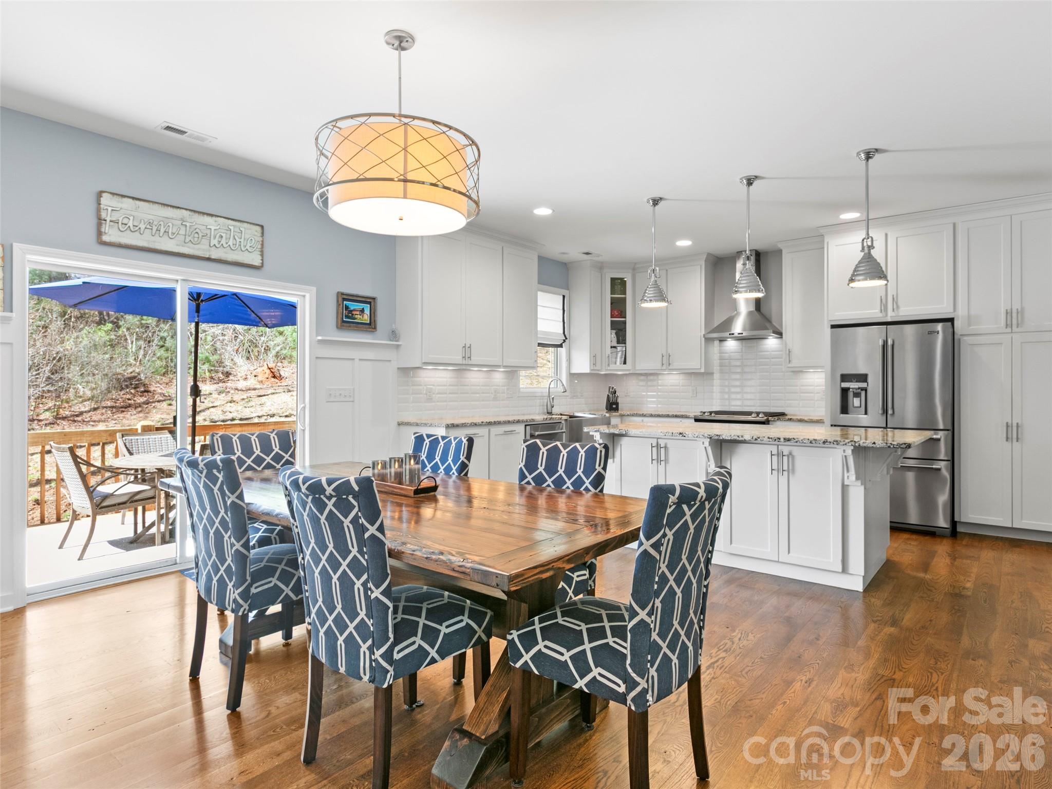 Elegant open dining area enhanced by a distinctive accent wall and custom shelving, blending character with functional design - 290 Sweetwater Hills Drive, Hendersonville