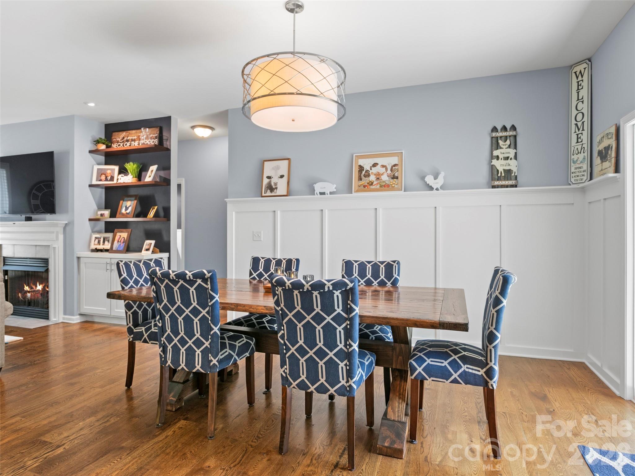 Bright and inviting dining space with seamless flow, highlighted by a custom accent wall and thoughtfully designed display shelf - 290 Sweetwater Hills Drive, Hendersonville