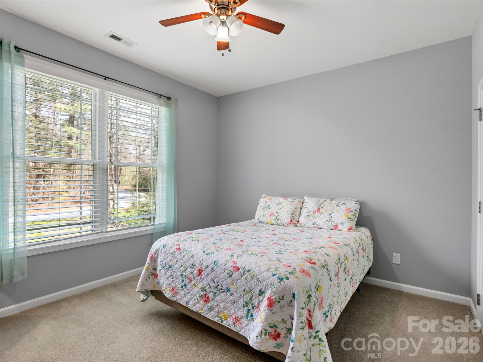 Comfortable main-level bedroom featuring ample closet space and convenient access to a shared full bath - 290 Sweetwater Hills Drive, Hendersonville