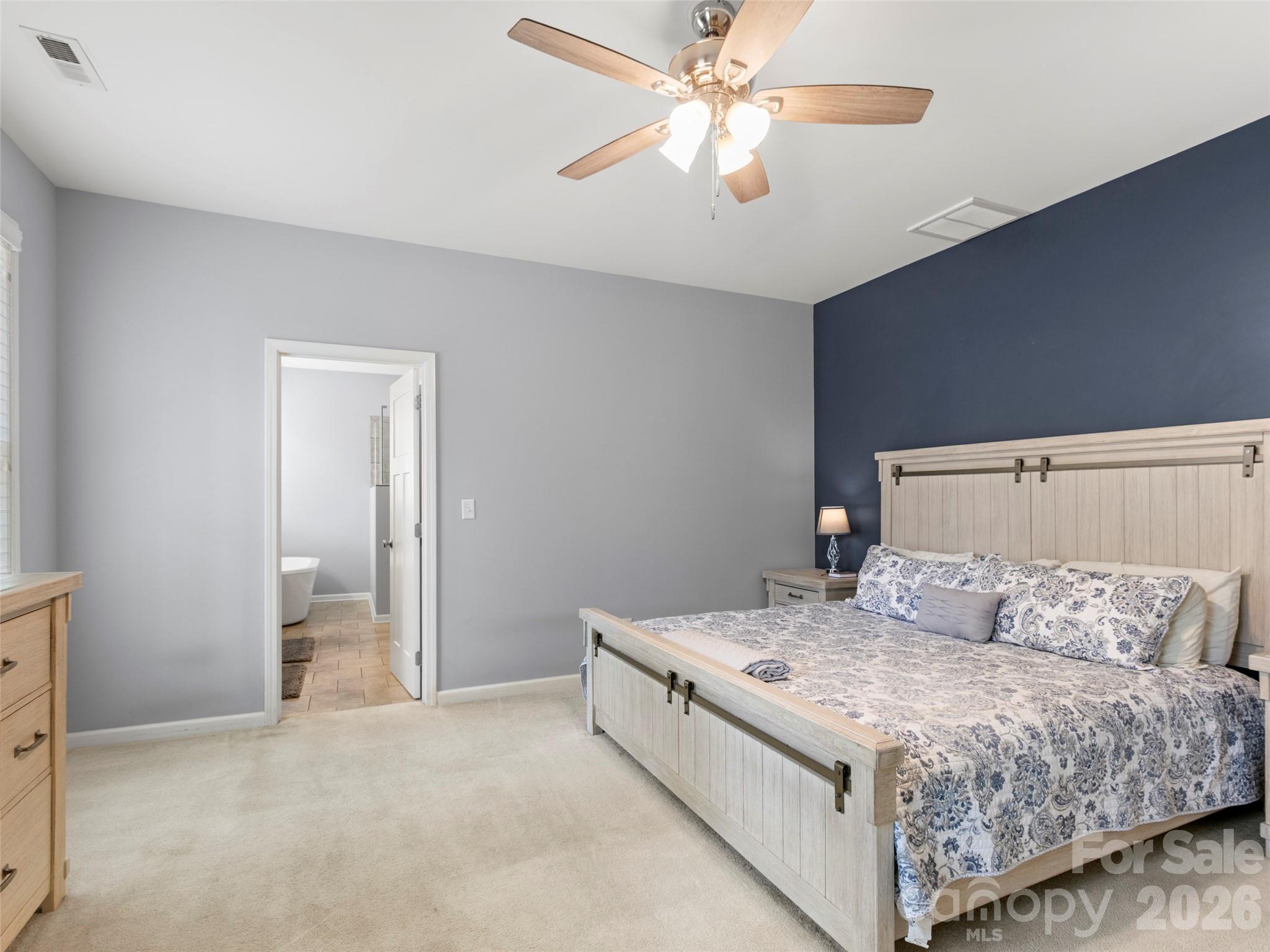 Expansive primary suite with a sophisticated feel, providing a private and comfortable escape at the end of the day - 290 Sweetwater Hills Drive, Hendersonville