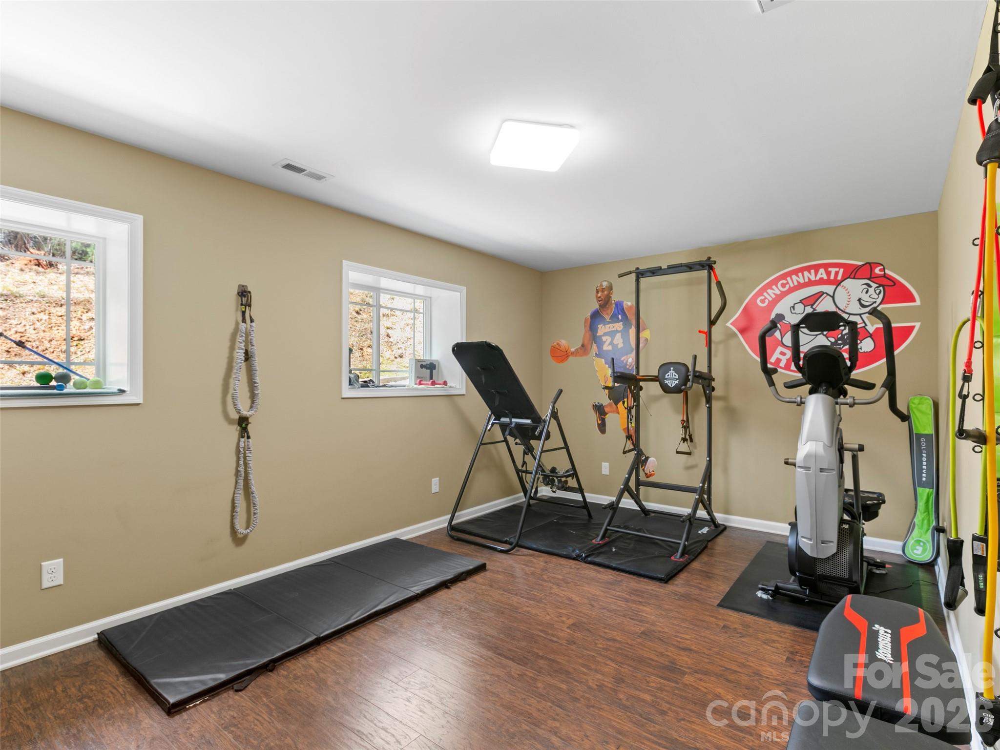 Versatile fitness room providing a dedicated area for strength training, cardio, and overall wellness - 290 Sweetwater Hills Drive, Hendersonville