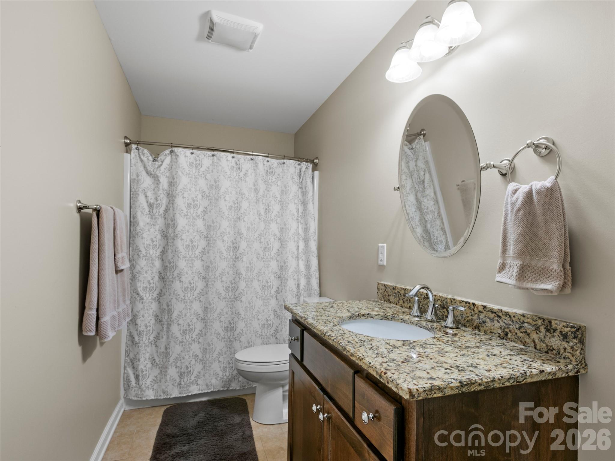 Comfortable downstairs bedroom featuring a full bath and spacious walk-in closet for convenience and privacy - 290 Sweetwater Hills Drive, Hendersonville