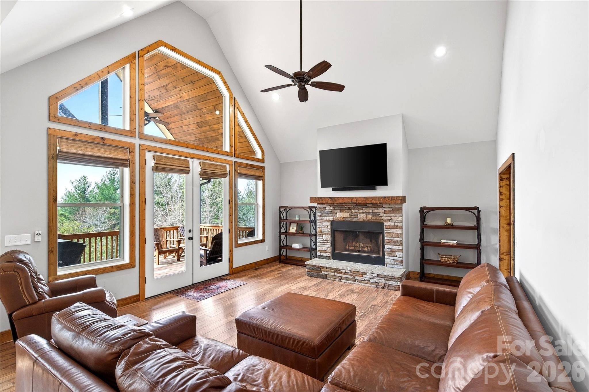 Stone wood-burning fireplace anchors the great room - 207 Lake Crest Drive, Nebo