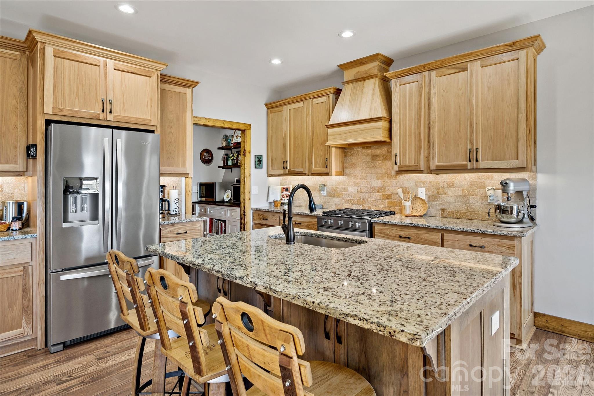 Island seating for four; stainless appliances and hickory cabinetry - 207 Lake Crest Drive, Nebo