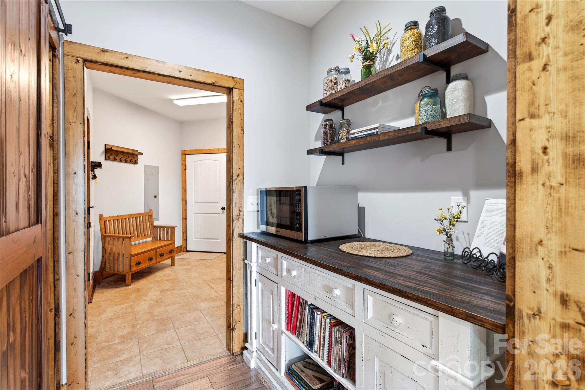 Butler's pantry and coffee bar behind a sliding barn door - 207 Lake Crest Drive, Nebo