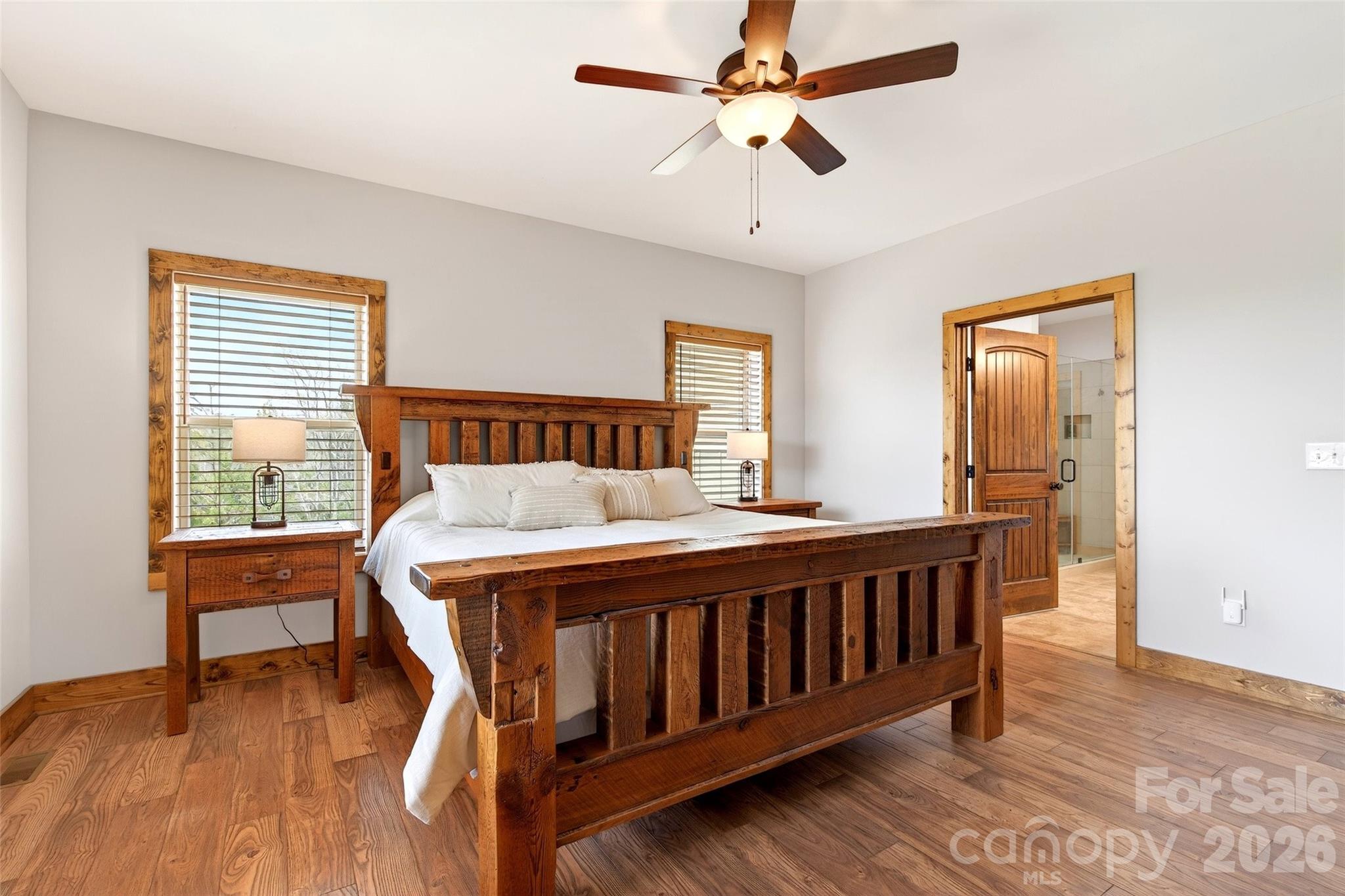 Primary bedroom, second view: two windows and en-suite bath beyond - 207 Lake Crest Drive, Nebo