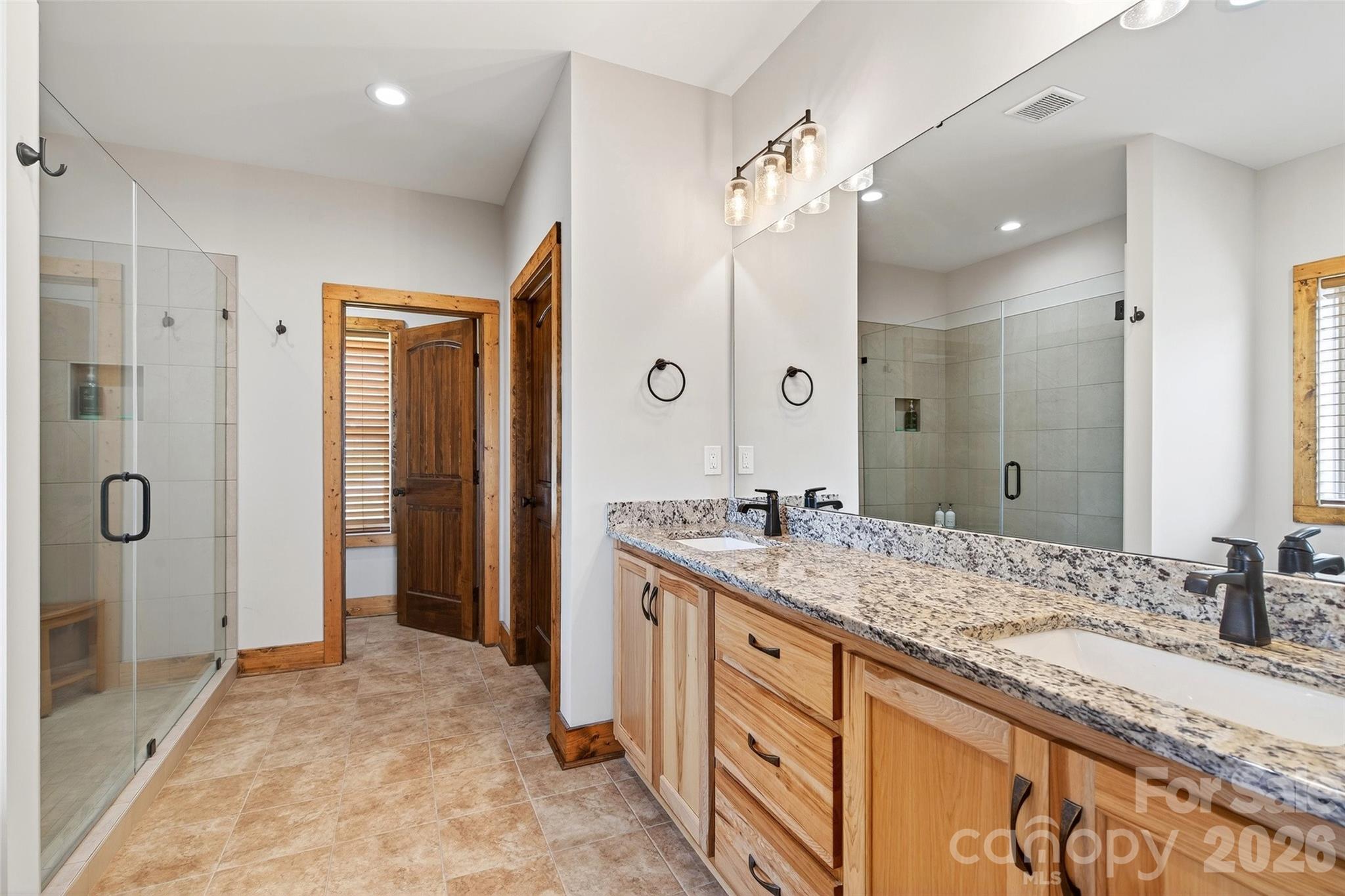 Primary bath: double granite vanity and walk-in tile shower - 207 Lake Crest Drive, Nebo