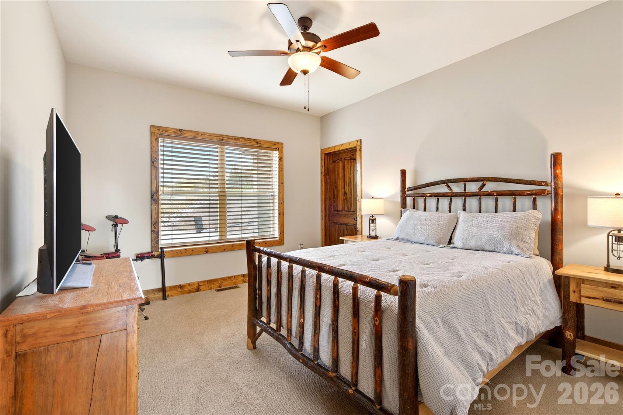 Second main-level bedroom with hardwood floors and view window - 207 Lake Crest Drive, Nebo