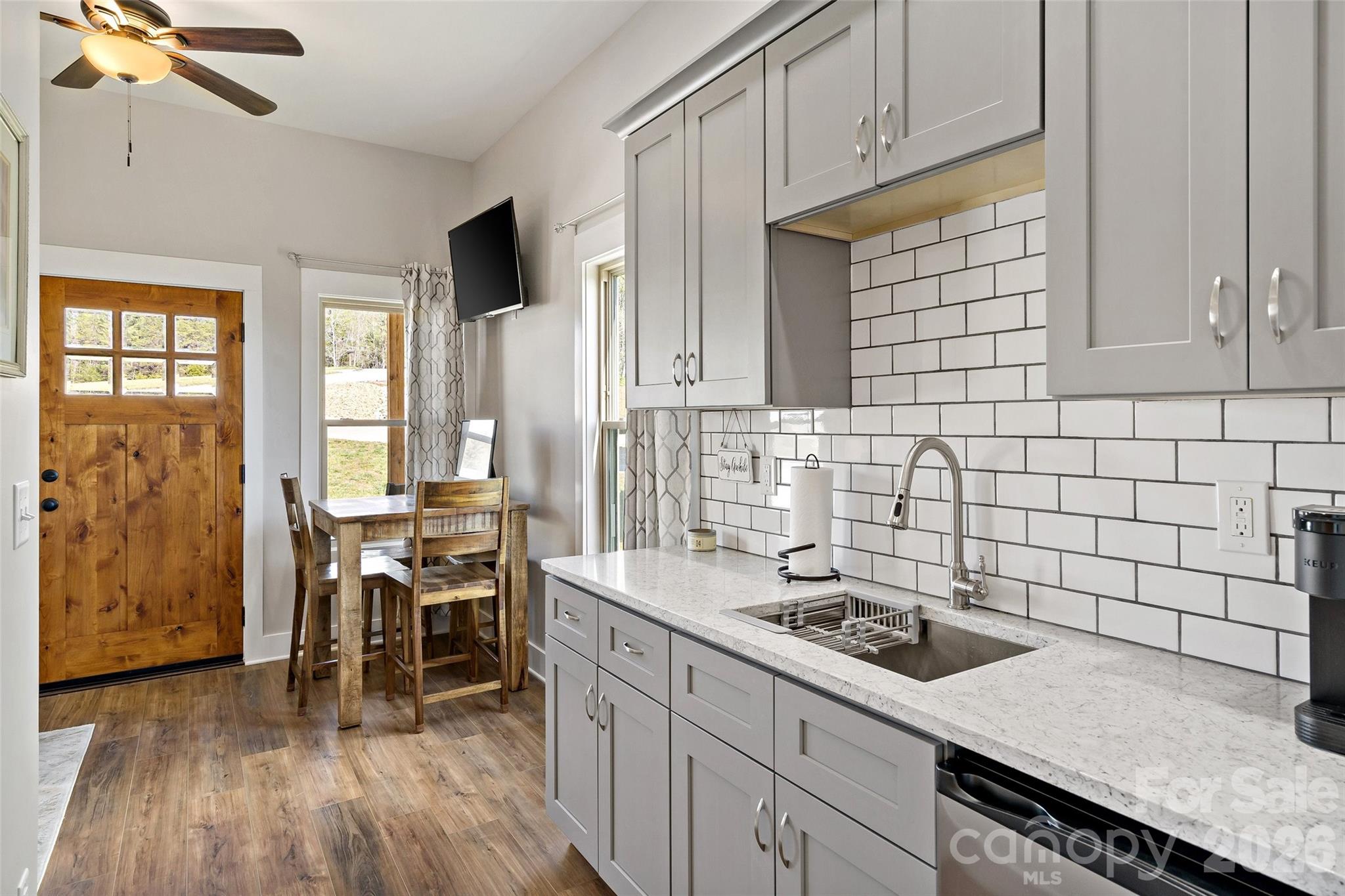 Guest suite kitchenette with quartz counters and subway tile - 207 Lake Crest Drive, Nebo