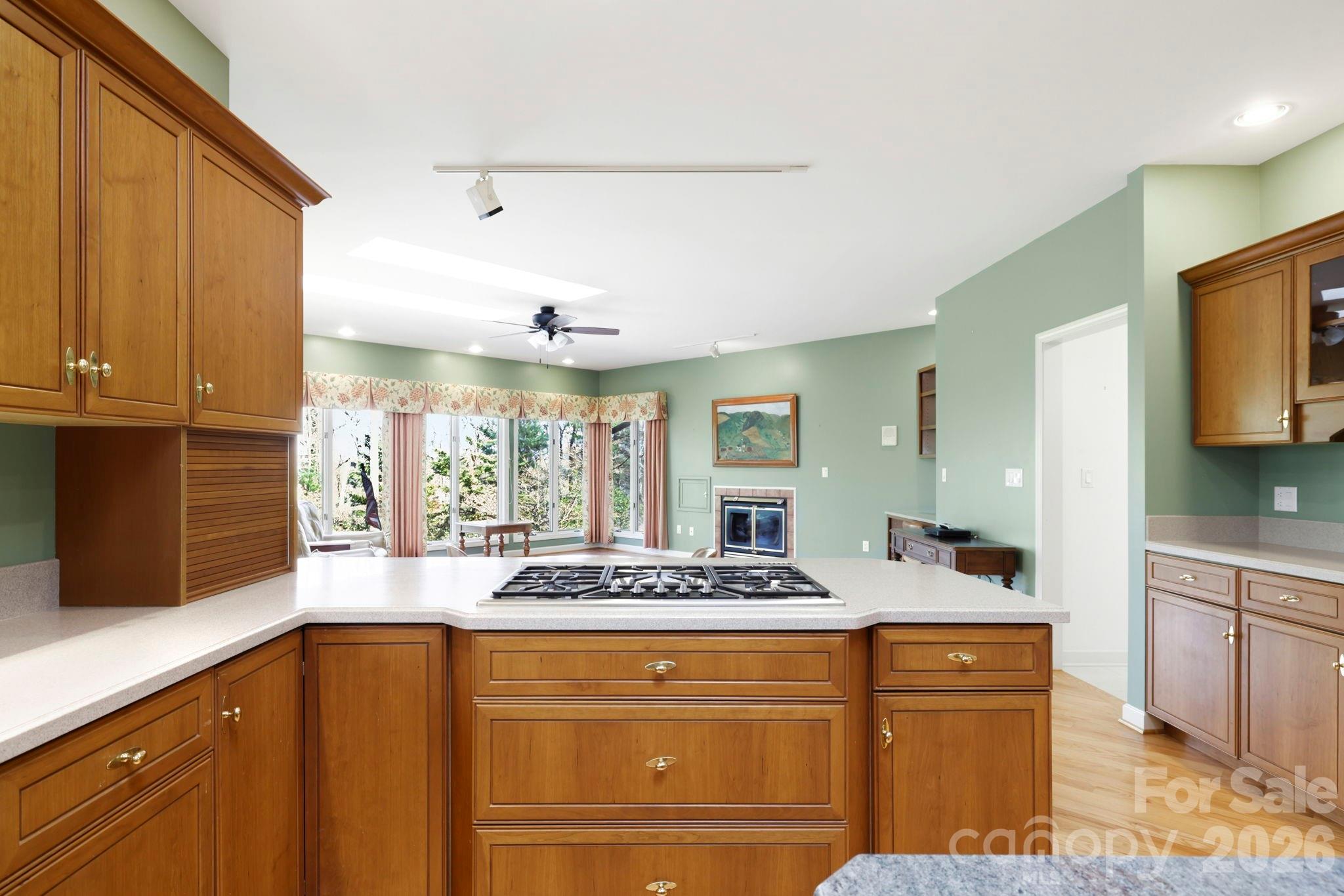 Kitchen opens to cozy den with fireplace - 100 Elmridge Drive, Flat Rock