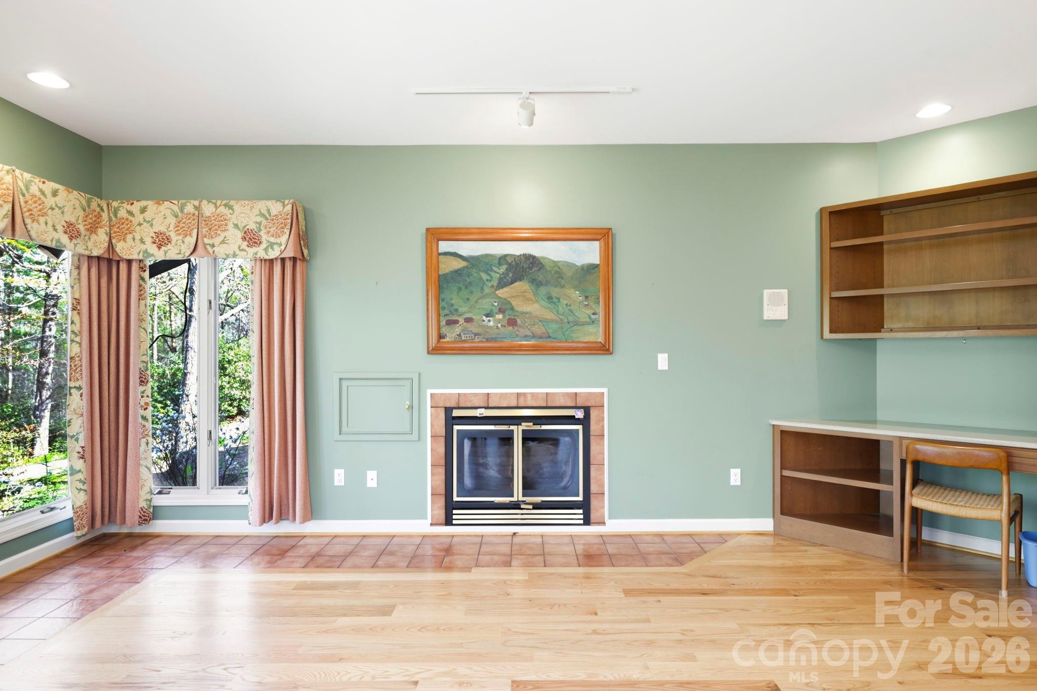 Den includes desk area. Little door next to fireplace is to bring wood in from garage. - 100 Elmridge Drive, Flat Rock