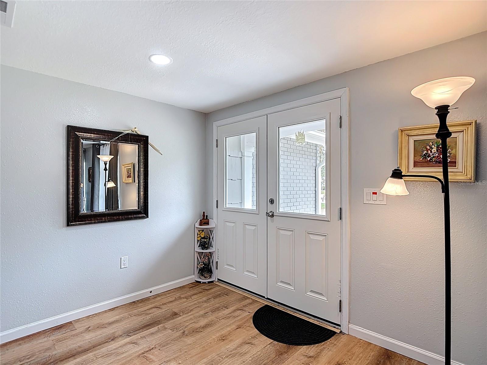 Foyer with a new hurricane rated entry door replaced in 2024-2025. - 12709 CASTLEBERRY CT, HUDSON