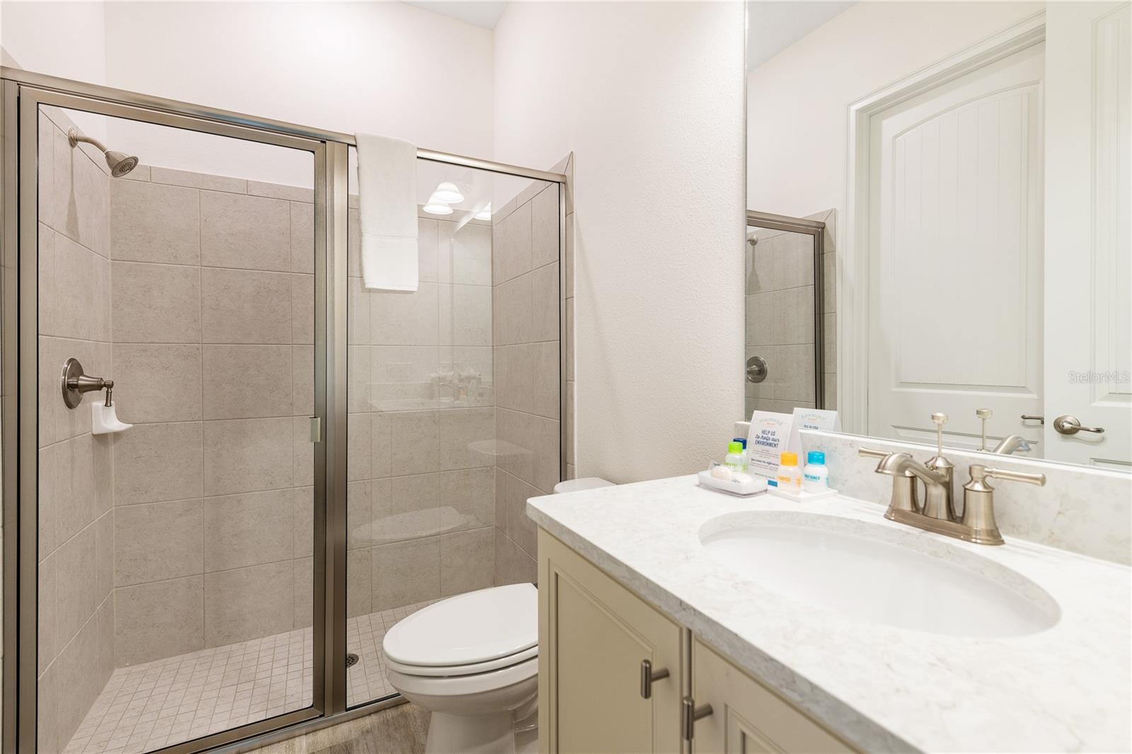 Modern full bathroom with walk in shower and upgraded finishes in Margaritaville Resort Orlando - 8075 KNEE DEEP RD, KISSIMMEE