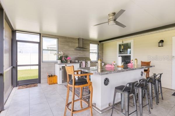 Dining and kitchen areas in lanai - 4382 FINCH LN, KISSIMMEE
