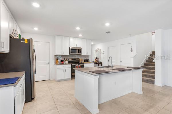 Kitchen and view upstairs - 4382 FINCH LN, KISSIMMEE