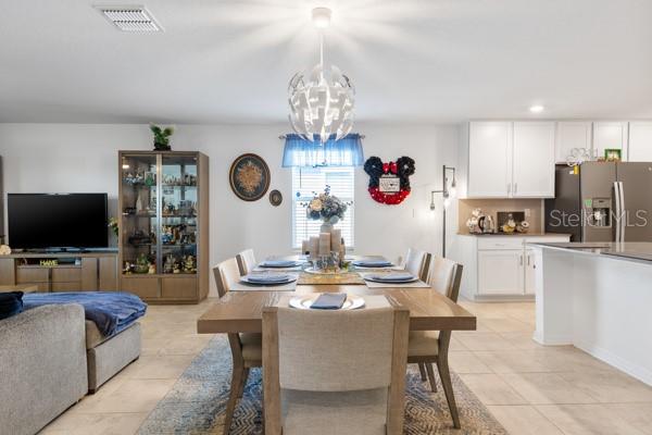 Dining area showing current arrangement - 4382 FINCH LN, KISSIMMEE