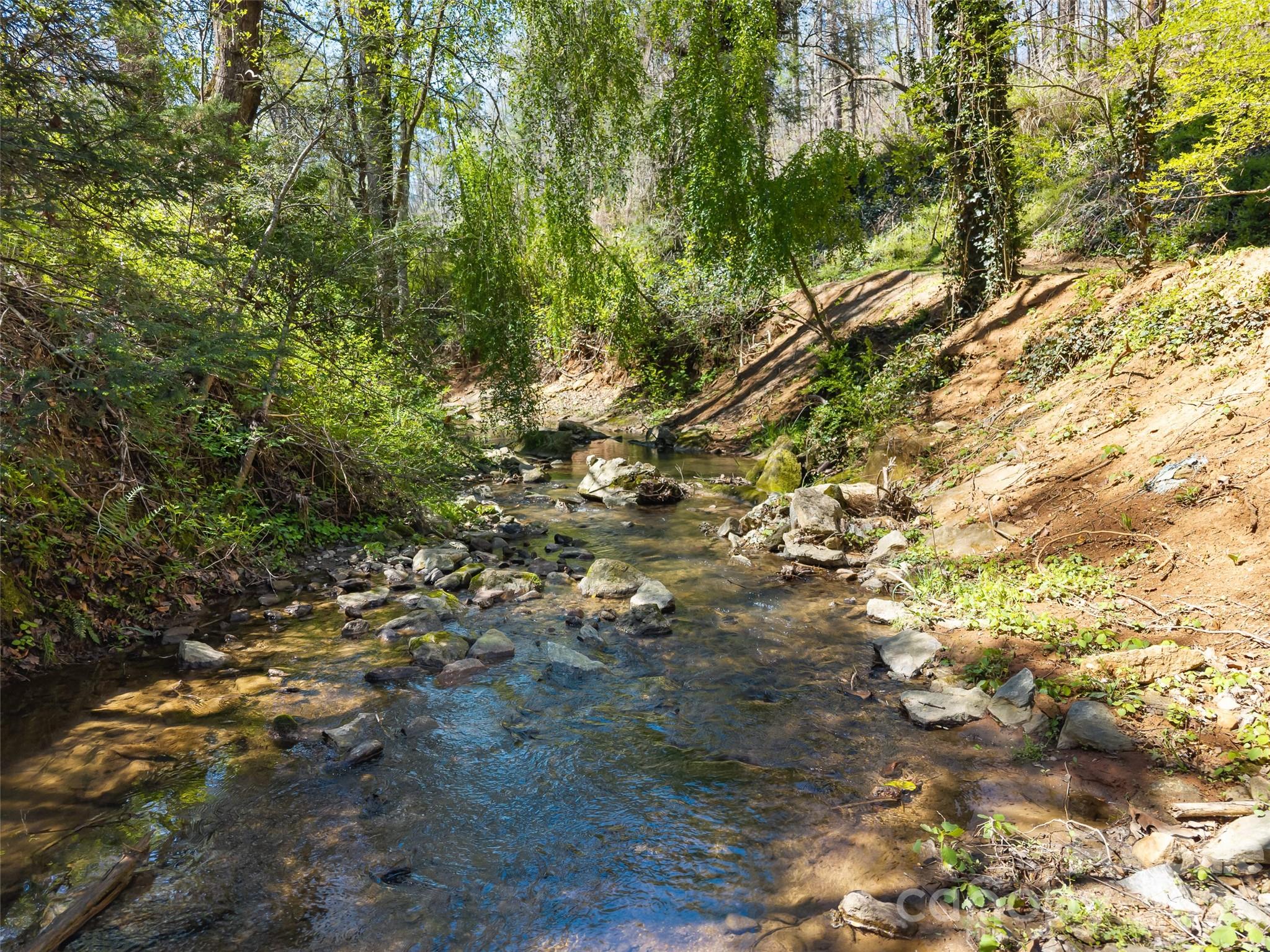 Creek runs throughout much of the 2+ acres - 40 Morning Dove Lane, Flat Rock
