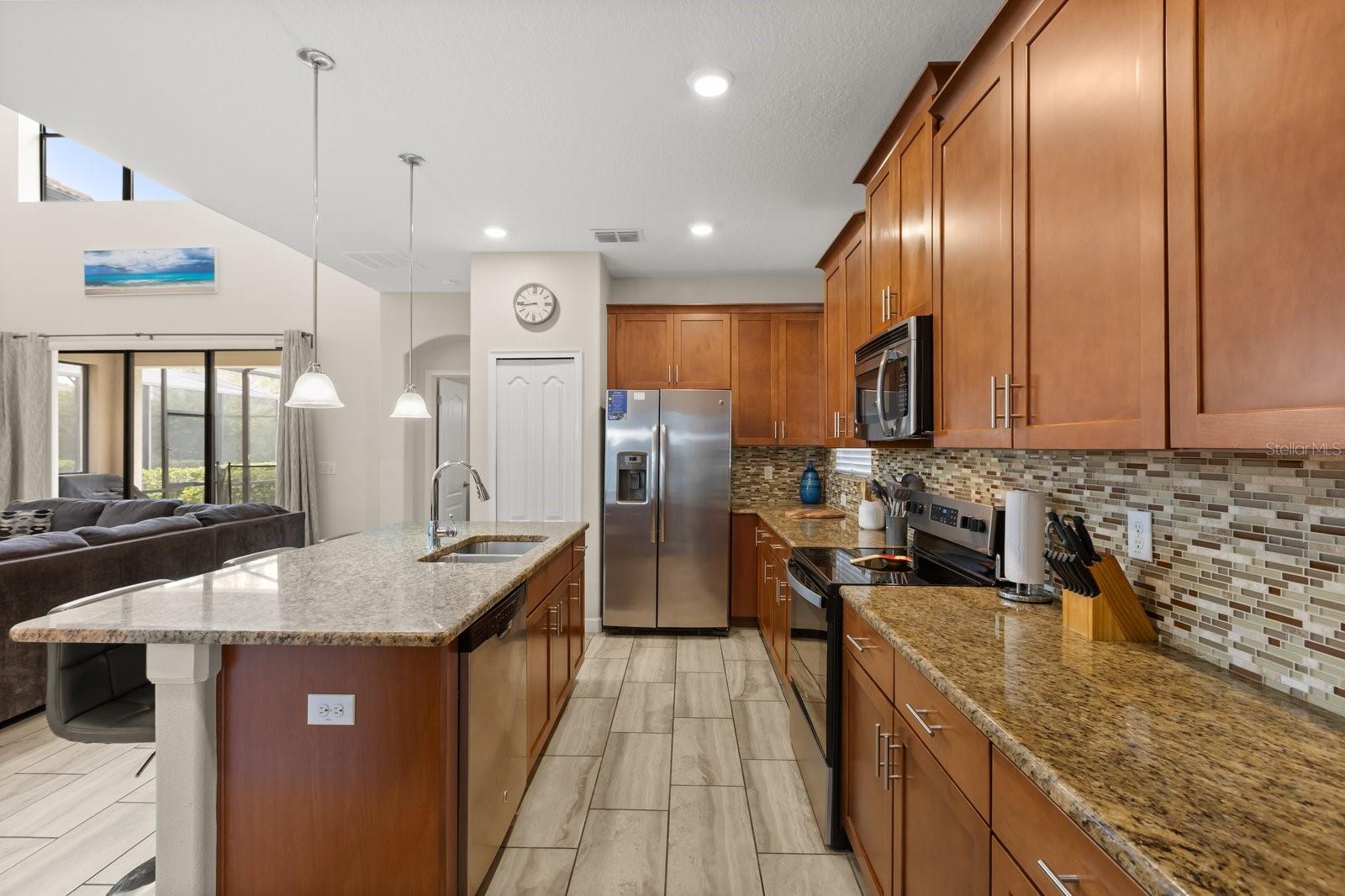 Kitchen with granite countertops and stainless steel applicances - 5493 SOLTERRA CIR, DAVENPORT