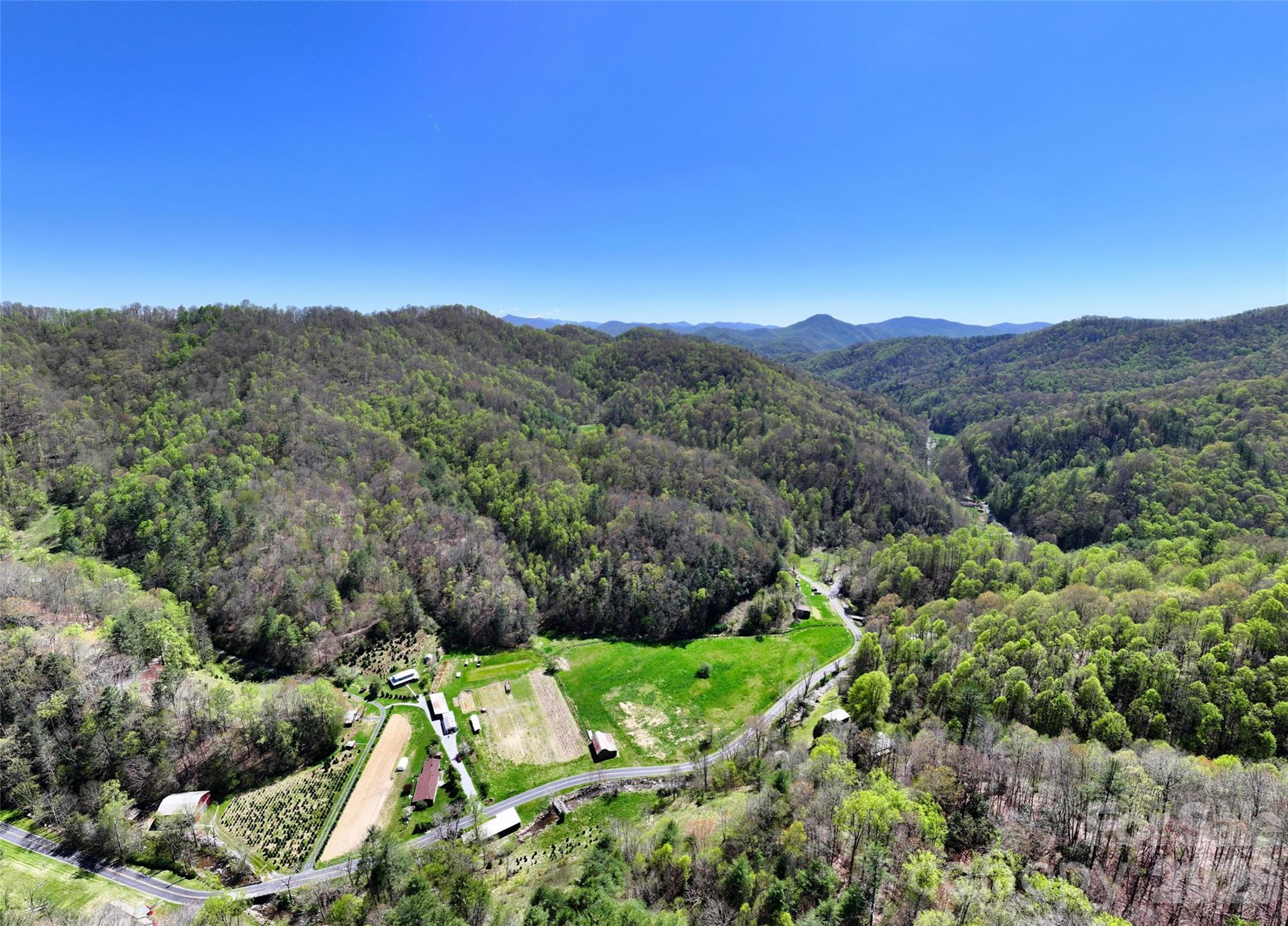 Aerial of the large flat pasture with old apple tree in center -- just add horses! Also has small barn on perimeter - 2180 Pigeon Roost Road, Green Mountain