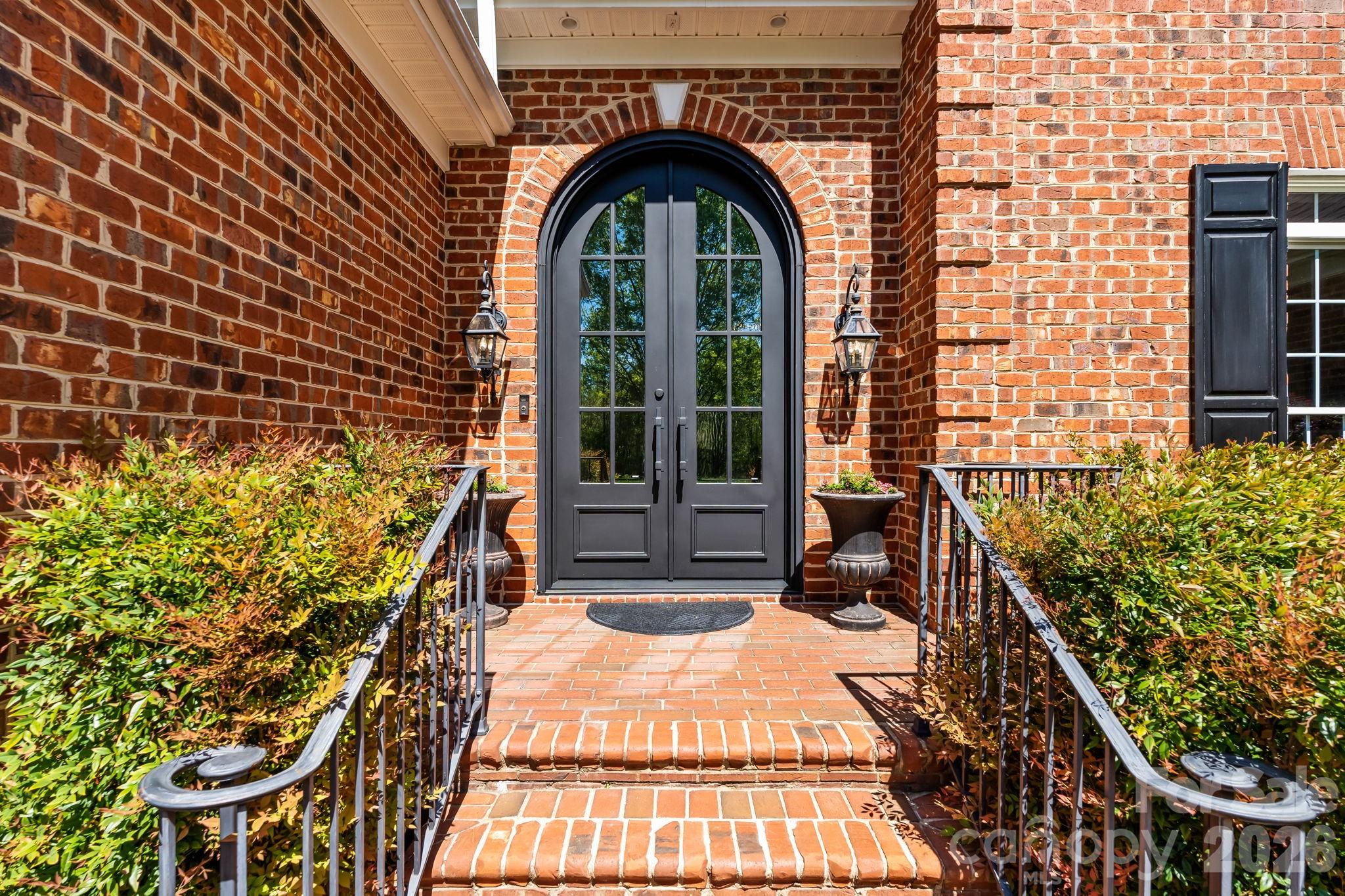 Custom made arched 10 ft steel doors welcome you in - 11555 Double Spring Road, Lewisville