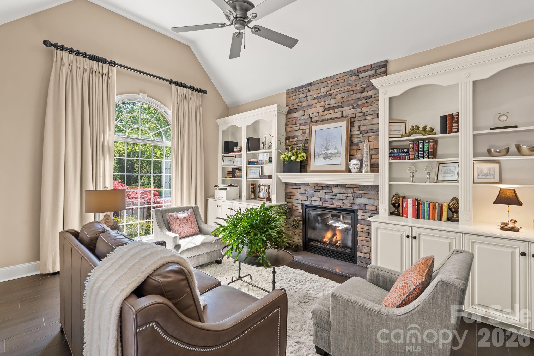 A relaxing spot for a good book and a warm fire. Stone fireplace with gas logs, built ins, and soaring ceilings. - 11555 Double Spring Road, Lewisville