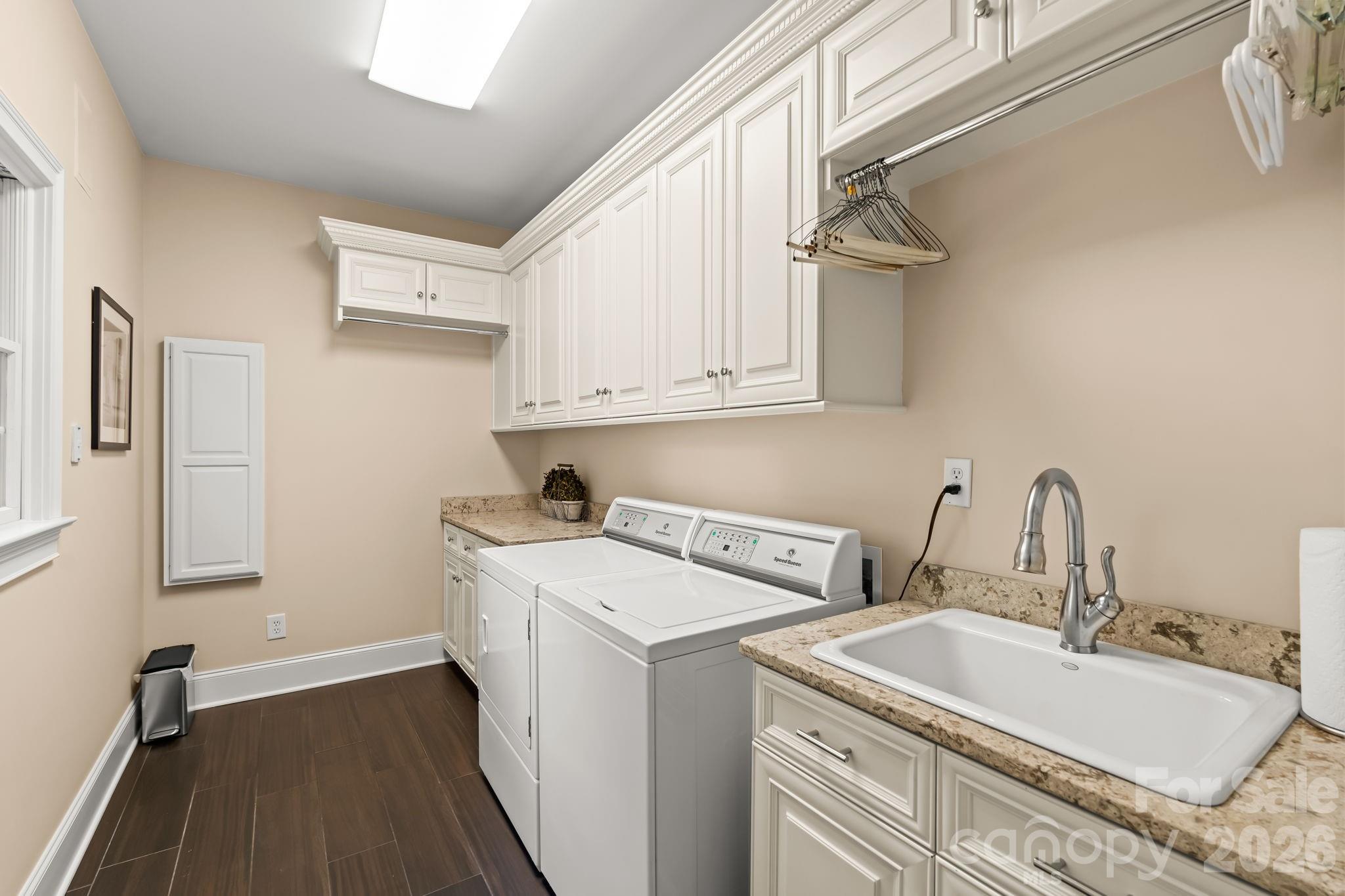 Main level laundry room with wash sink and storage - 11555 Double Spring Road, Lewisville