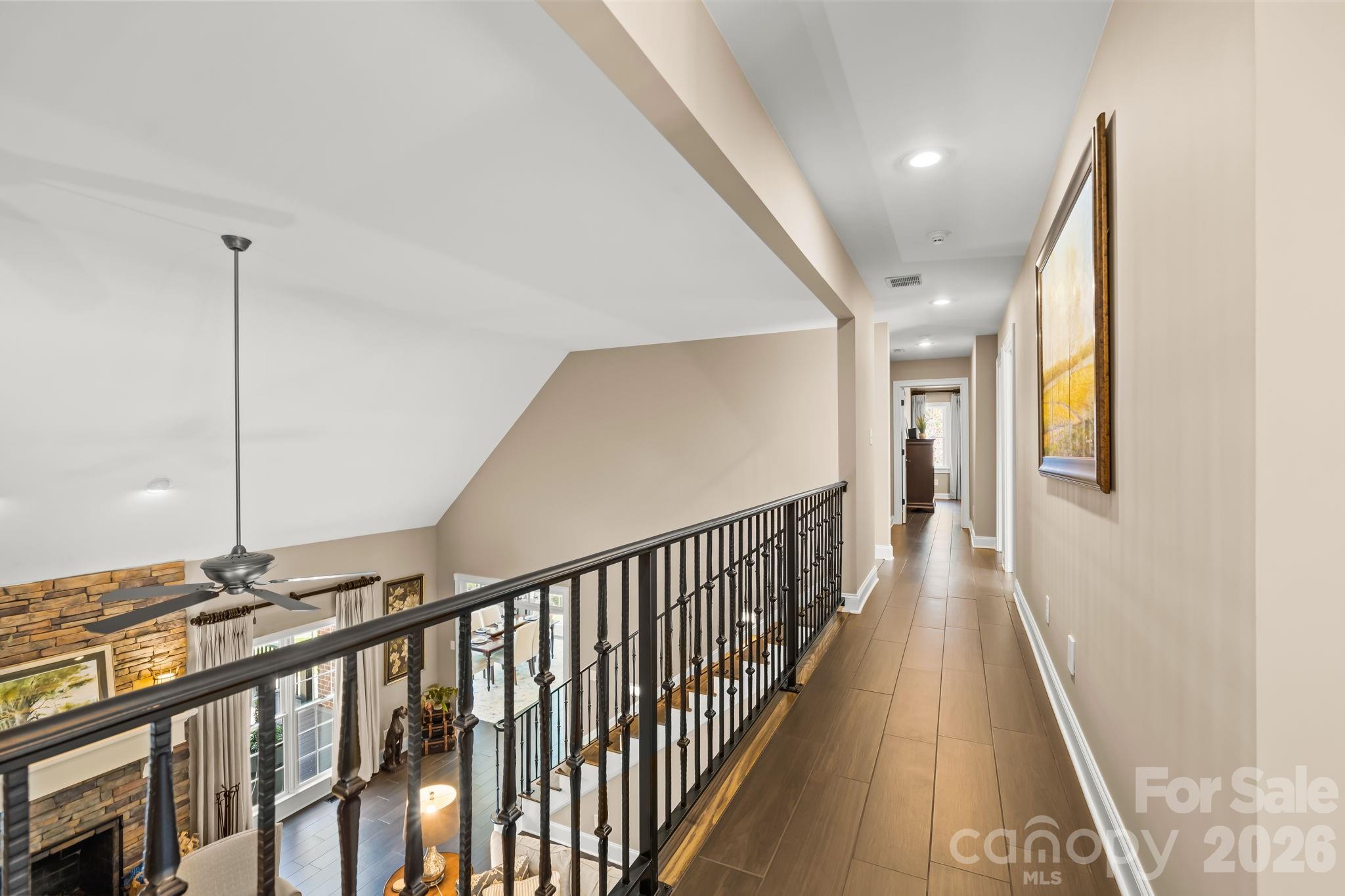 The custom iron railing is a stand out feature overlooking the great room. - 11555 Double Spring Road, Lewisville