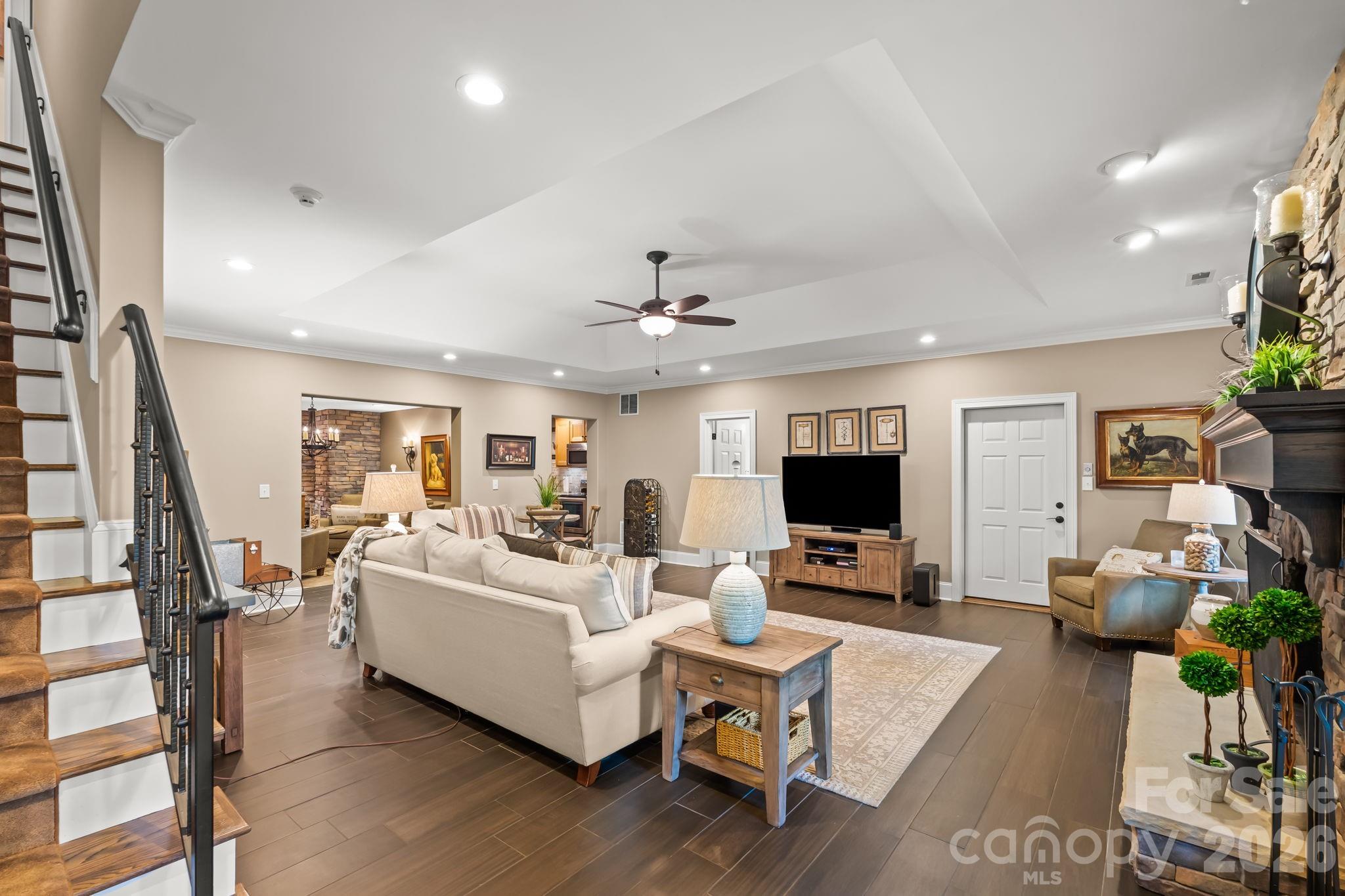 Luxurious lower level with stone fireplace, gas logs, extensive storage, kitchen, wine cellar, and garage bay. - 11555 Double Spring Road, Lewisville