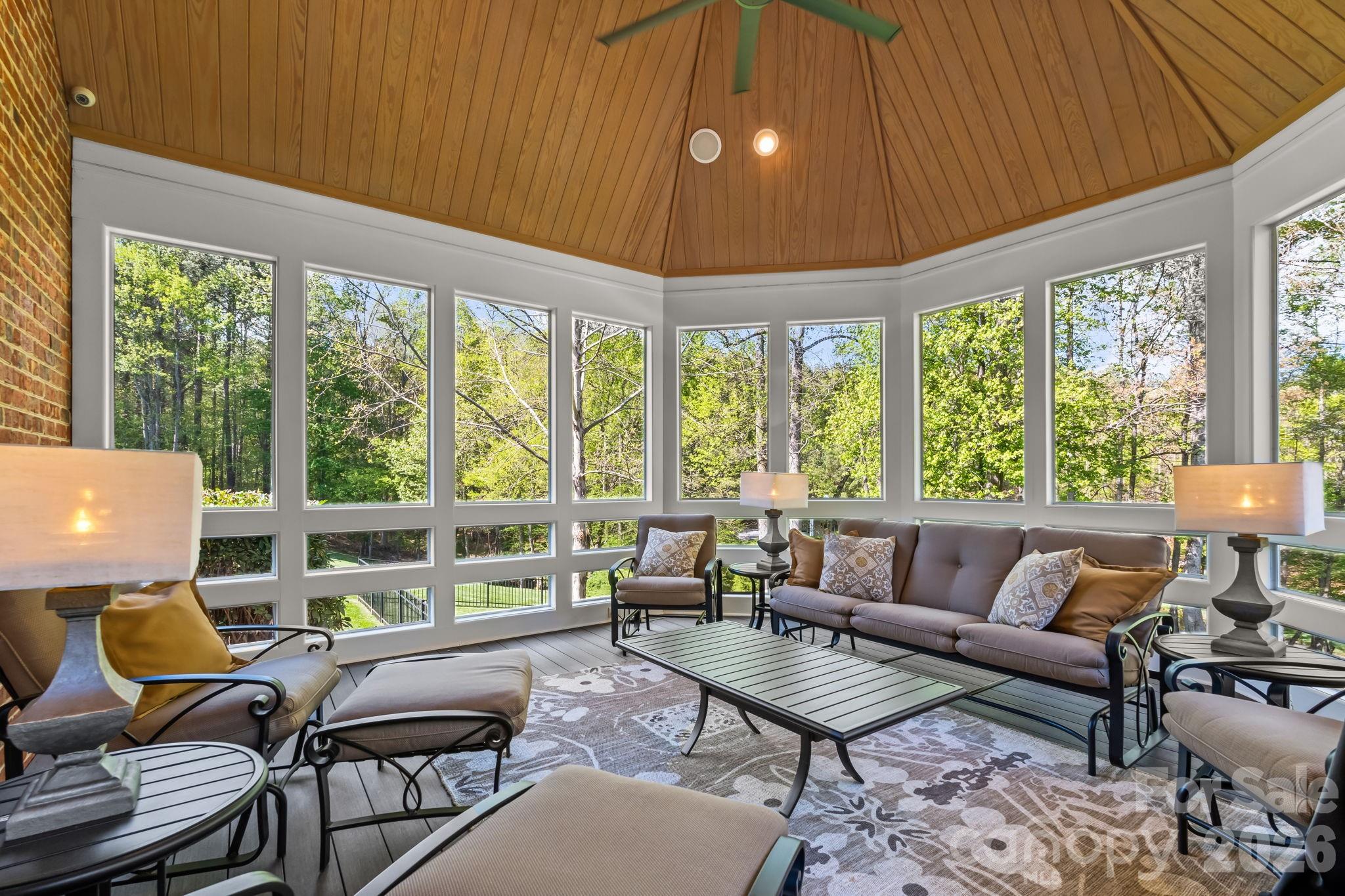The exceptional screened porch with low maintenance decking and vaulted ceiling offers extensive views of the property - 11555 Double Spring Road, Lewisville