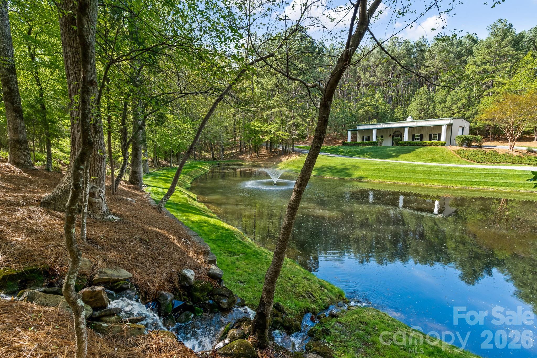 The scenic pond enhances the property and is also the source for whole property irrigation. Rainwater runoff is directed to the pond for replenishment. - 11555 Double Spring Road, Lewisville