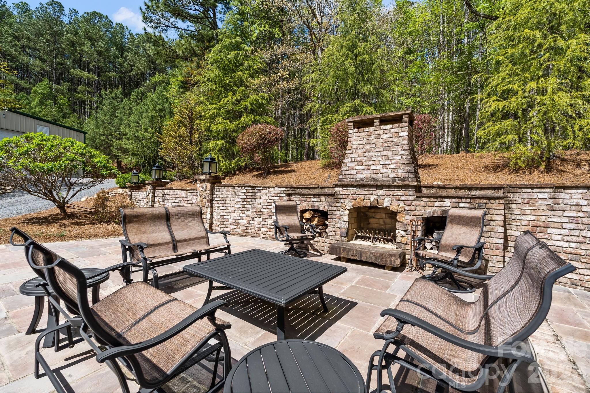 The outdoor brick fireplace and spacious bluestone patio are perfect for quiet evenings or large gatherings! - 11555 Double Spring Road, Lewisville