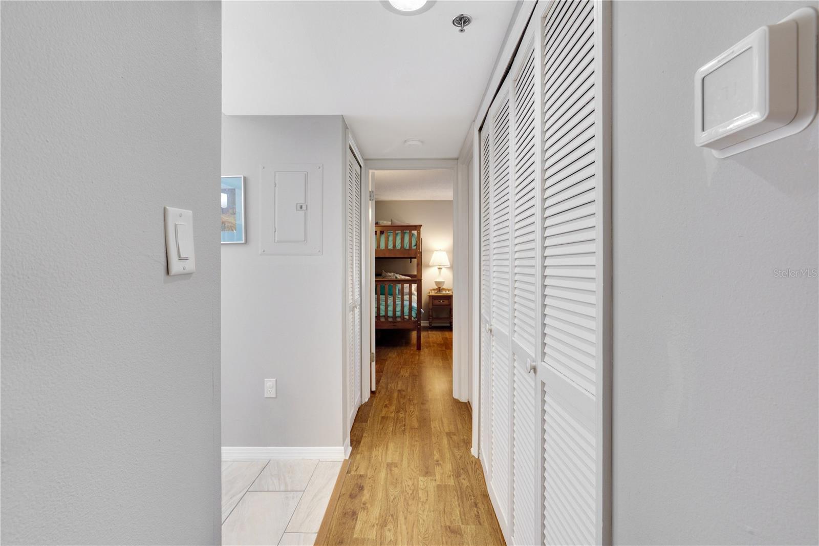 Hallway to 2nd Bedroom and Laundry Closet on Right - 204 QUAYSIDE CIR #201, MAITLAND