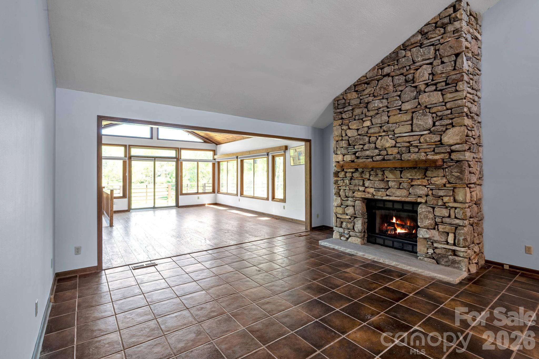 Open-concept transition connecting living space to sunroom - 3104 Cove Loop Road, Hendersonville
