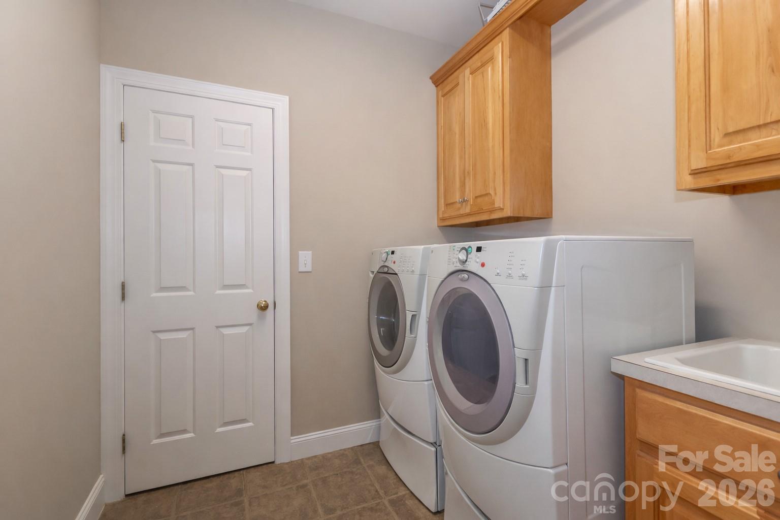 Laundry room is accessible from one of the primary bedroom closets - 119 Shelter Cove Lane, Mooresville