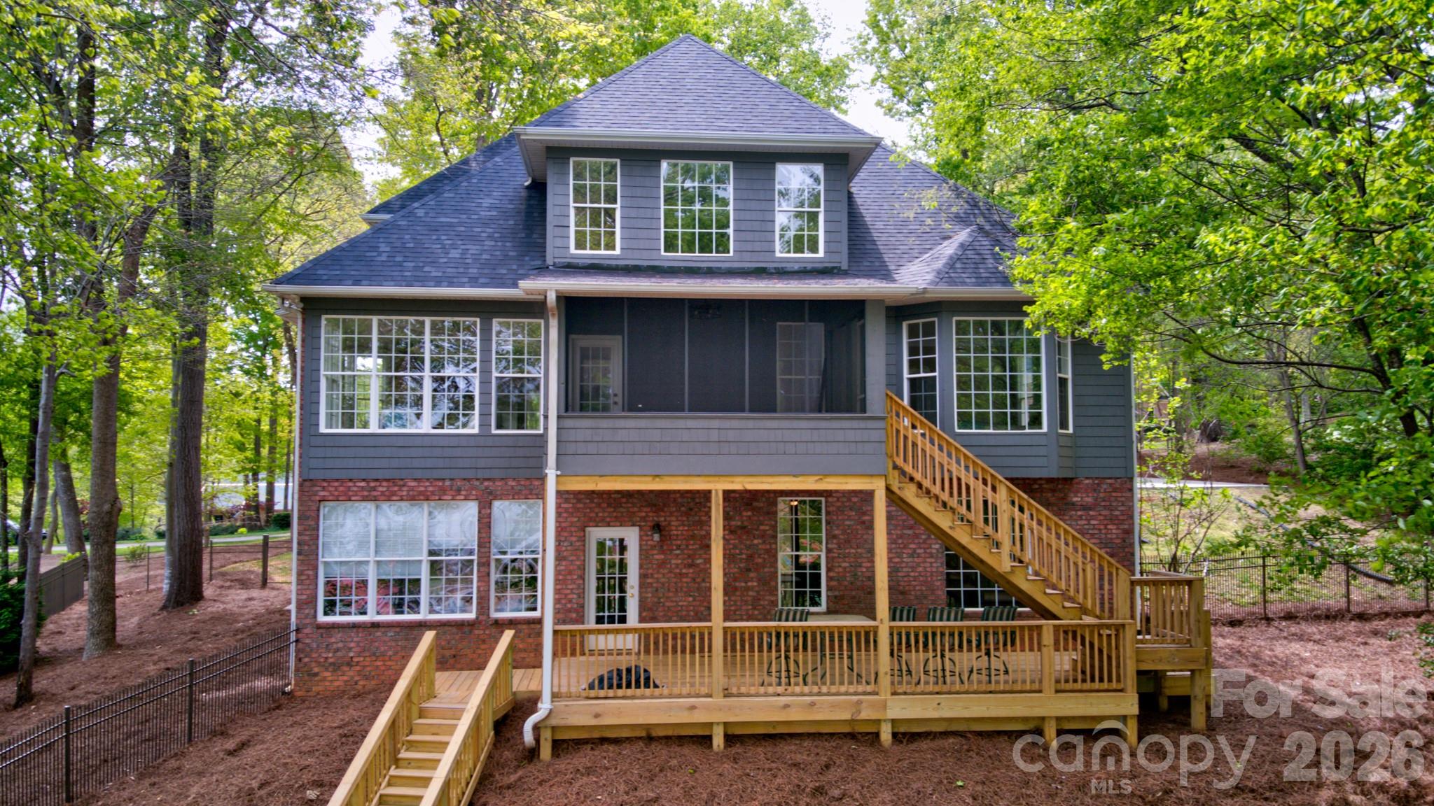 Gorgeous view of the back of the house from the lake. - 119 Shelter Cove Lane, Mooresville