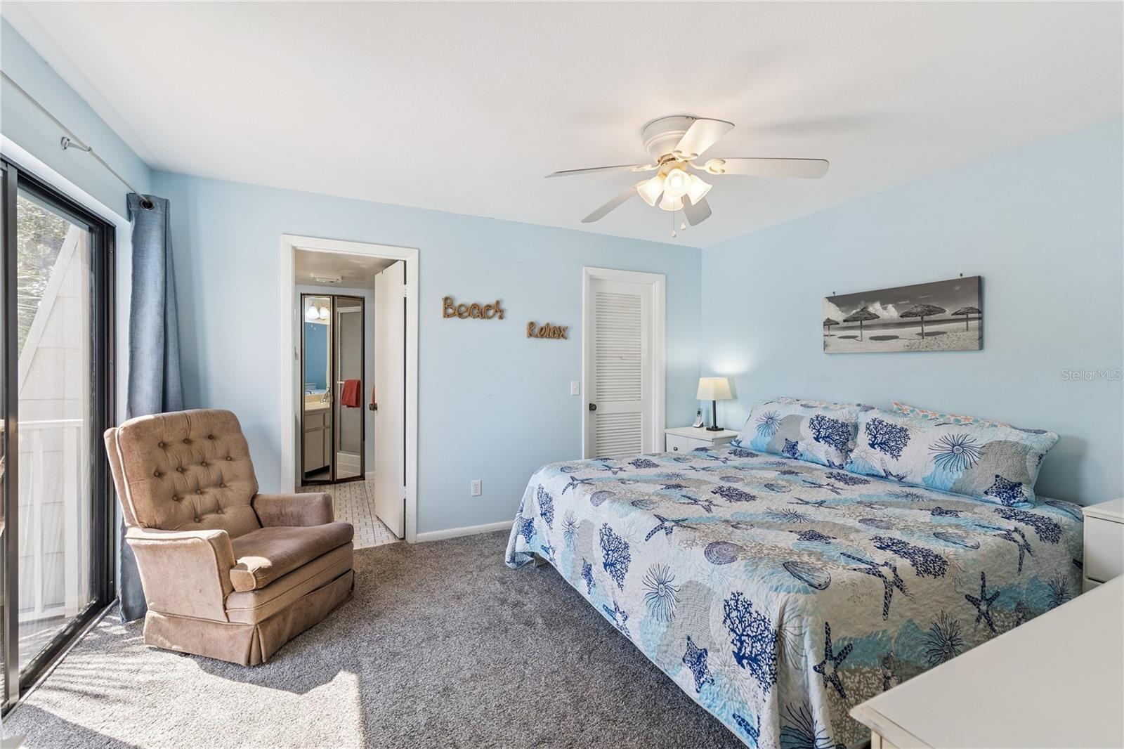 Primary Bedroom with Ensuite/Spacious Walk-In Closet/Sliding Glass Doors to Balcony - 4150 S ATLANTIC AVE #121B, NEW SMYRNA BEACH