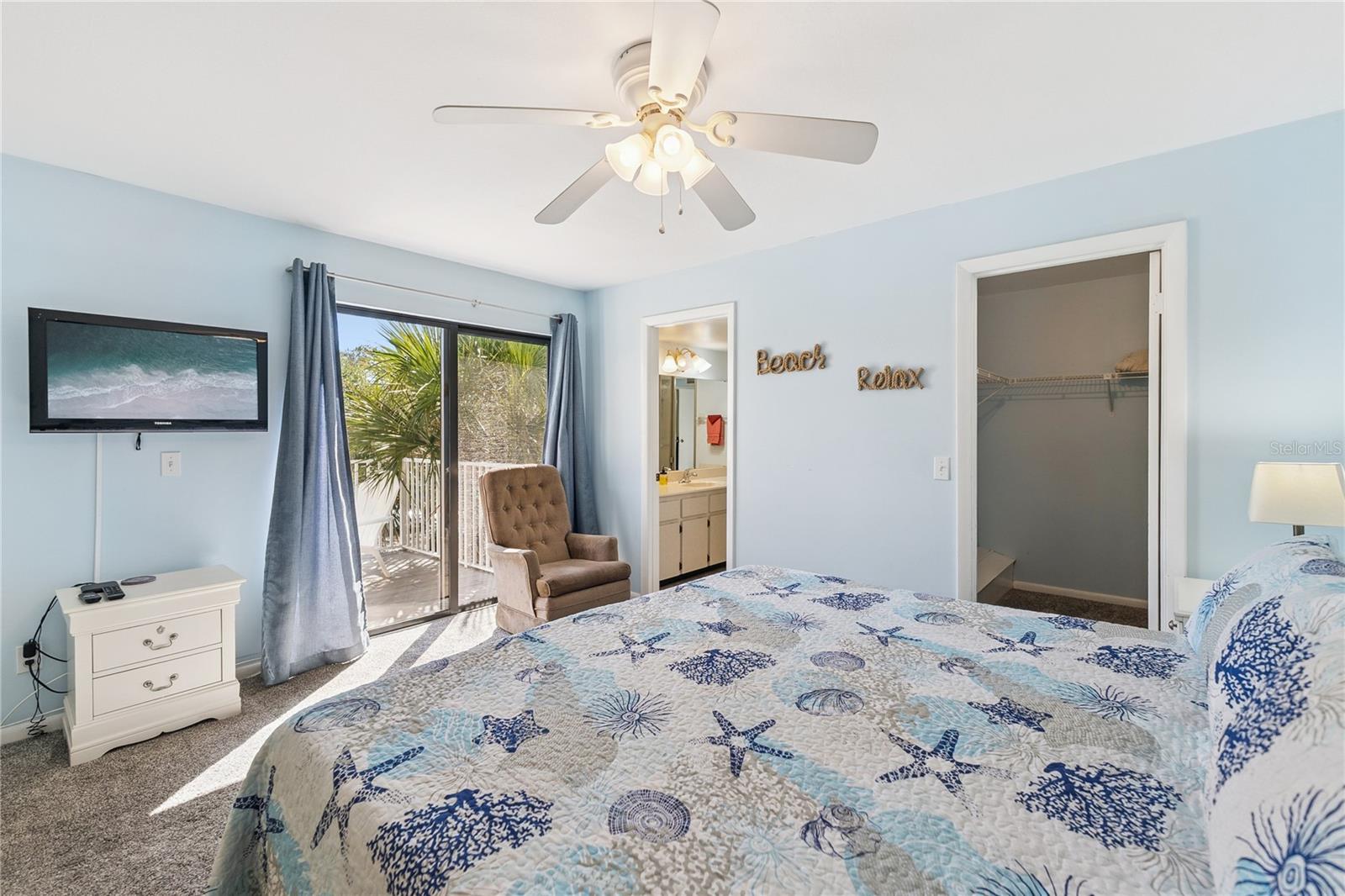 Primary Bedroom with Sliding Glass Doors to Balcony - 4150 S ATLANTIC AVE #121B, NEW SMYRNA BEACH