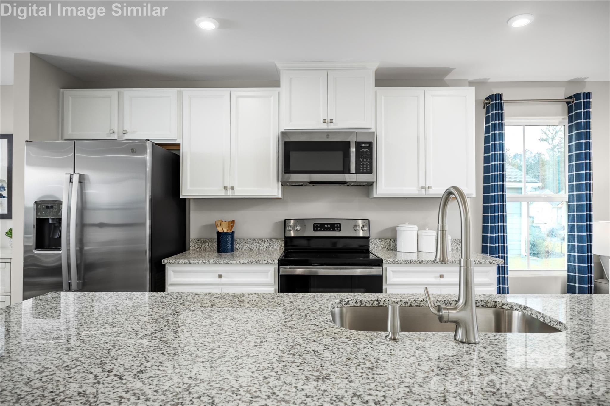 The stainless steel appliances add a sleek, contemporary touch—think professional-grade performance with a polished finish that complements any décor. From the refrigerator to the range, every detail is thoughtfully chosen to elevate your cooking experience. - 3271 Eller Drive Extension, Hickory