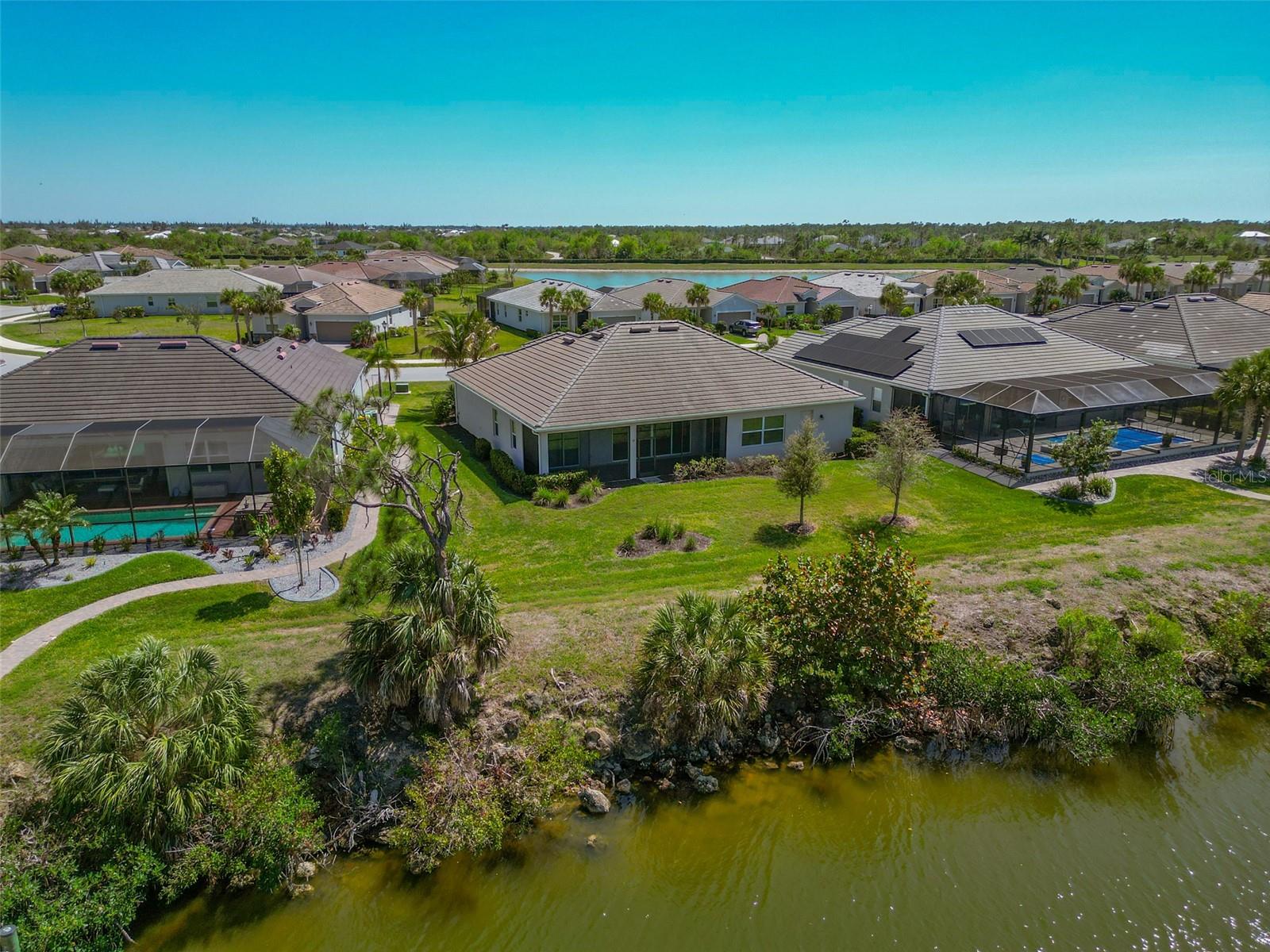Back of home with a view of the canal. - 14500 PONCE DE LEON TRL, PORT CHARLOTTE