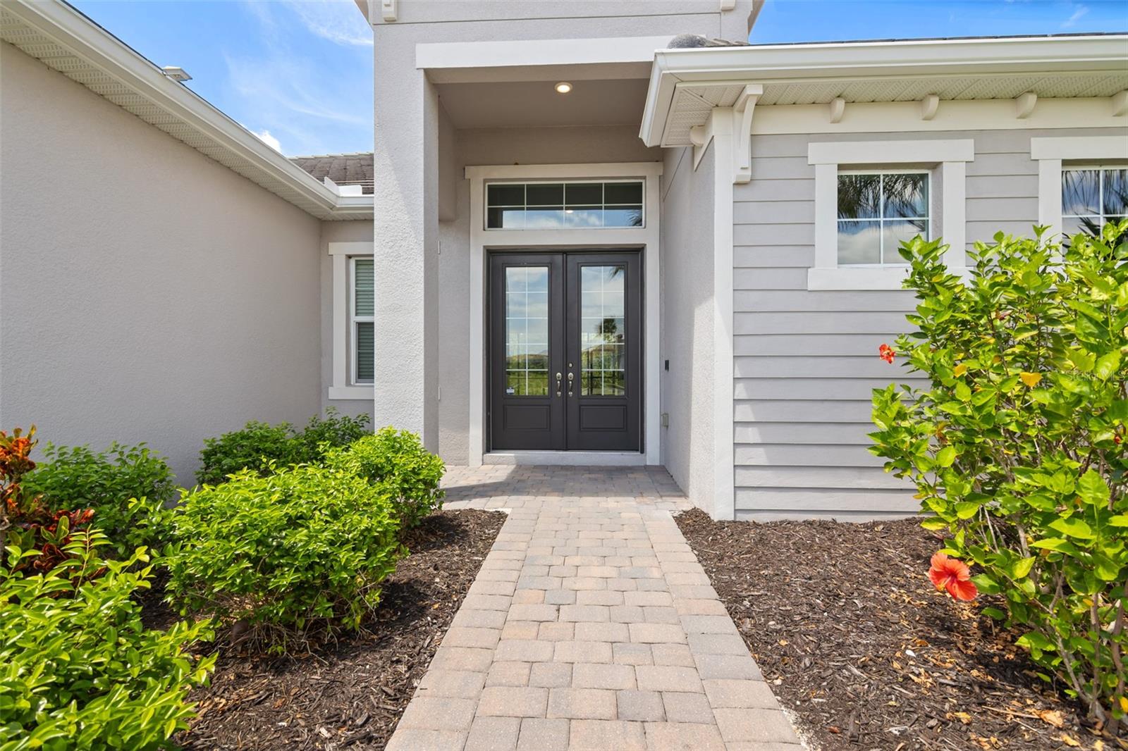Exterior view of the front door and walkway. - 14500 PONCE DE LEON TRL, PORT CHARLOTTE
