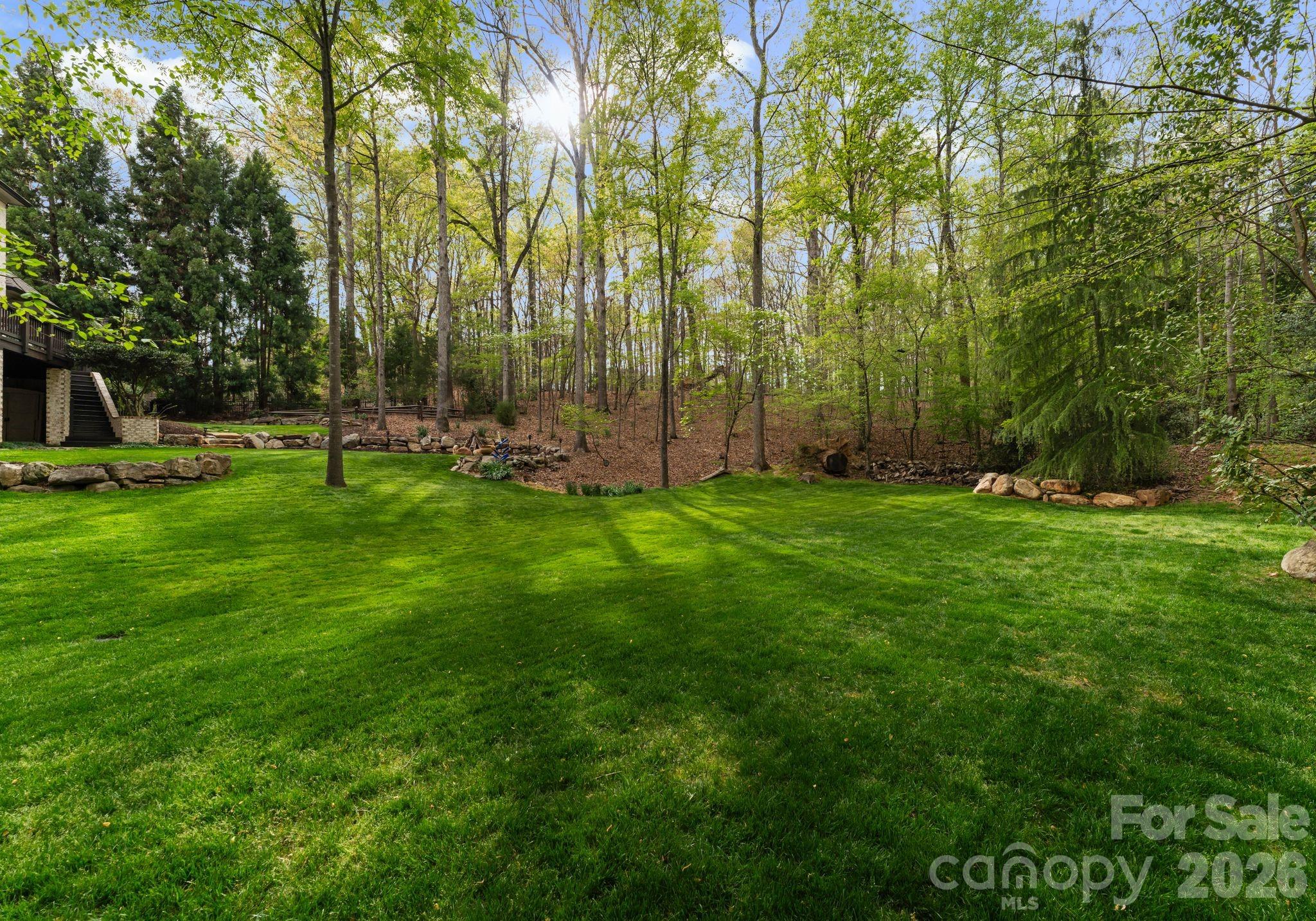 Expansive lower level of backyard surrounded by additional green space - 1514 Elmsford Lane, Matthews