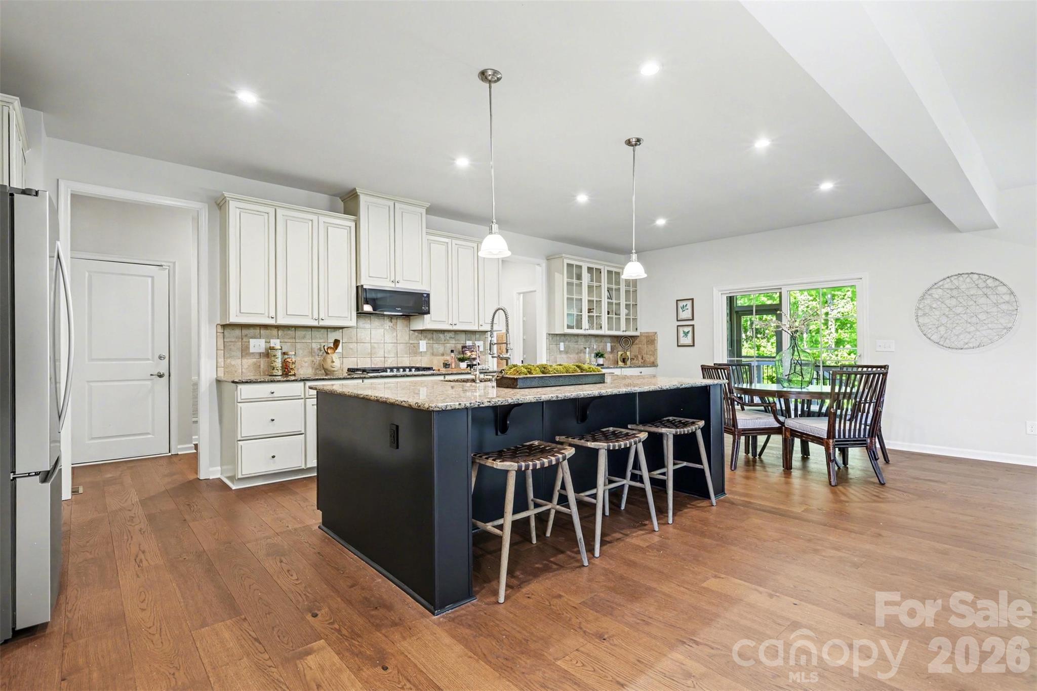 Large, open kitchen with ample cabinetry space and a expansive granite topped island. - 824 Abbeywood Drive, Waxhaw