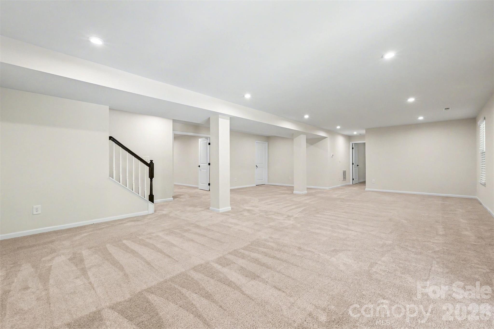 Stairs leading to lower level entertainment space. - 824 Abbeywood Drive, Waxhaw