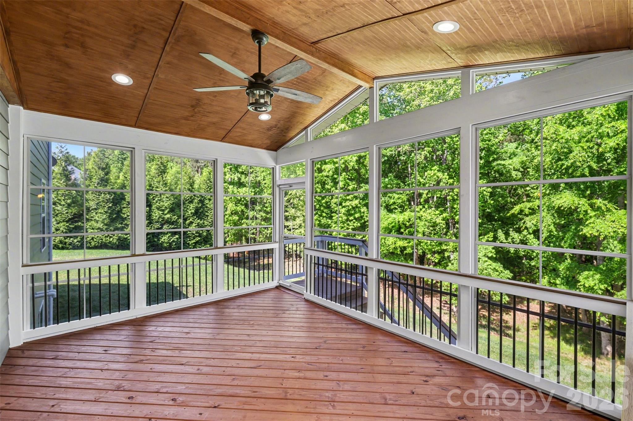 Beautifully appointed enclosed rear porch for additional outdoor entertaining or relaxing! - 824 Abbeywood Drive, Waxhaw