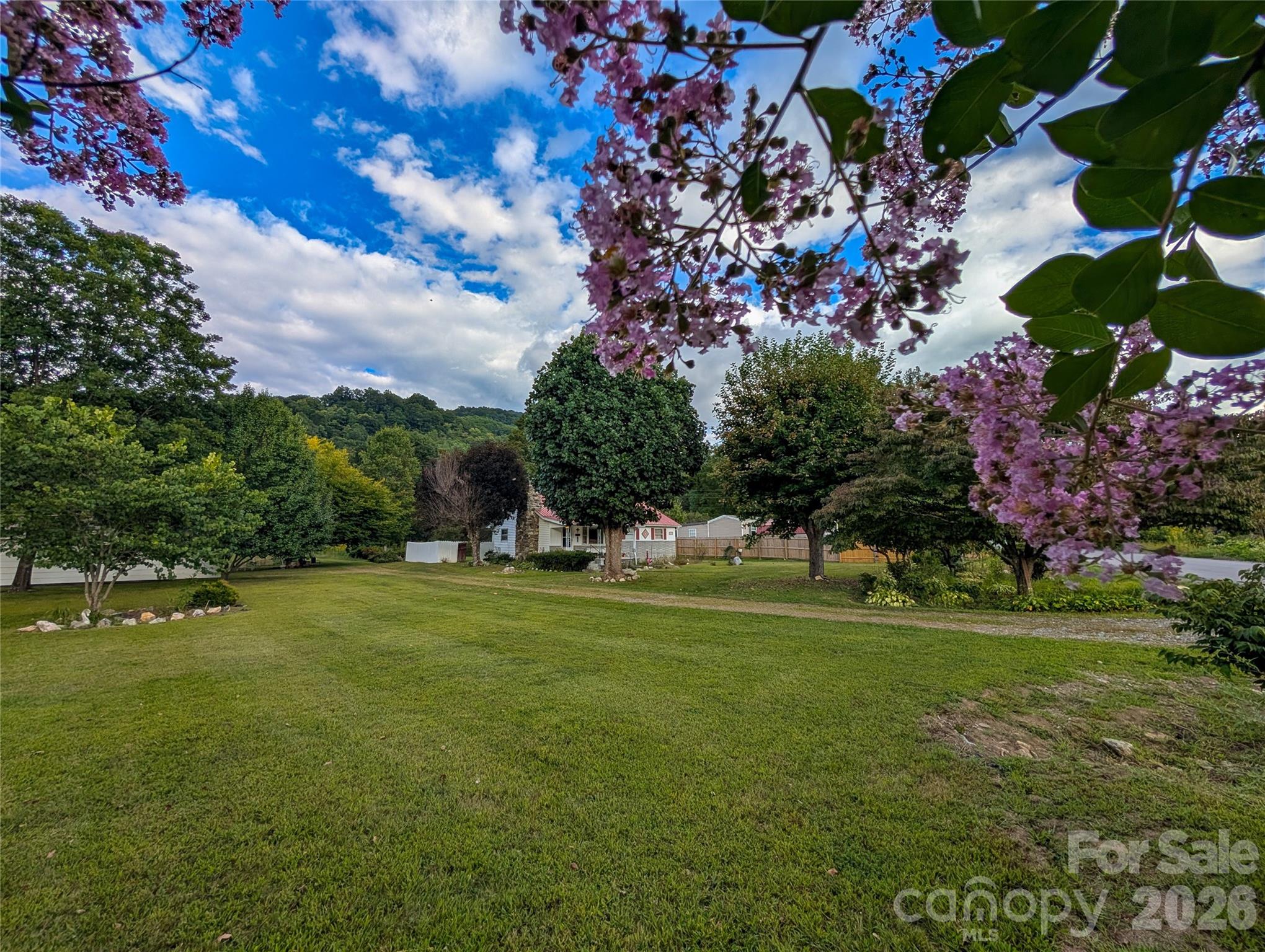This farmhouse has such a picturesque setting & is situated on 2.74 acres of level usable land! - 165 Cattail Creek Road, Burnsville