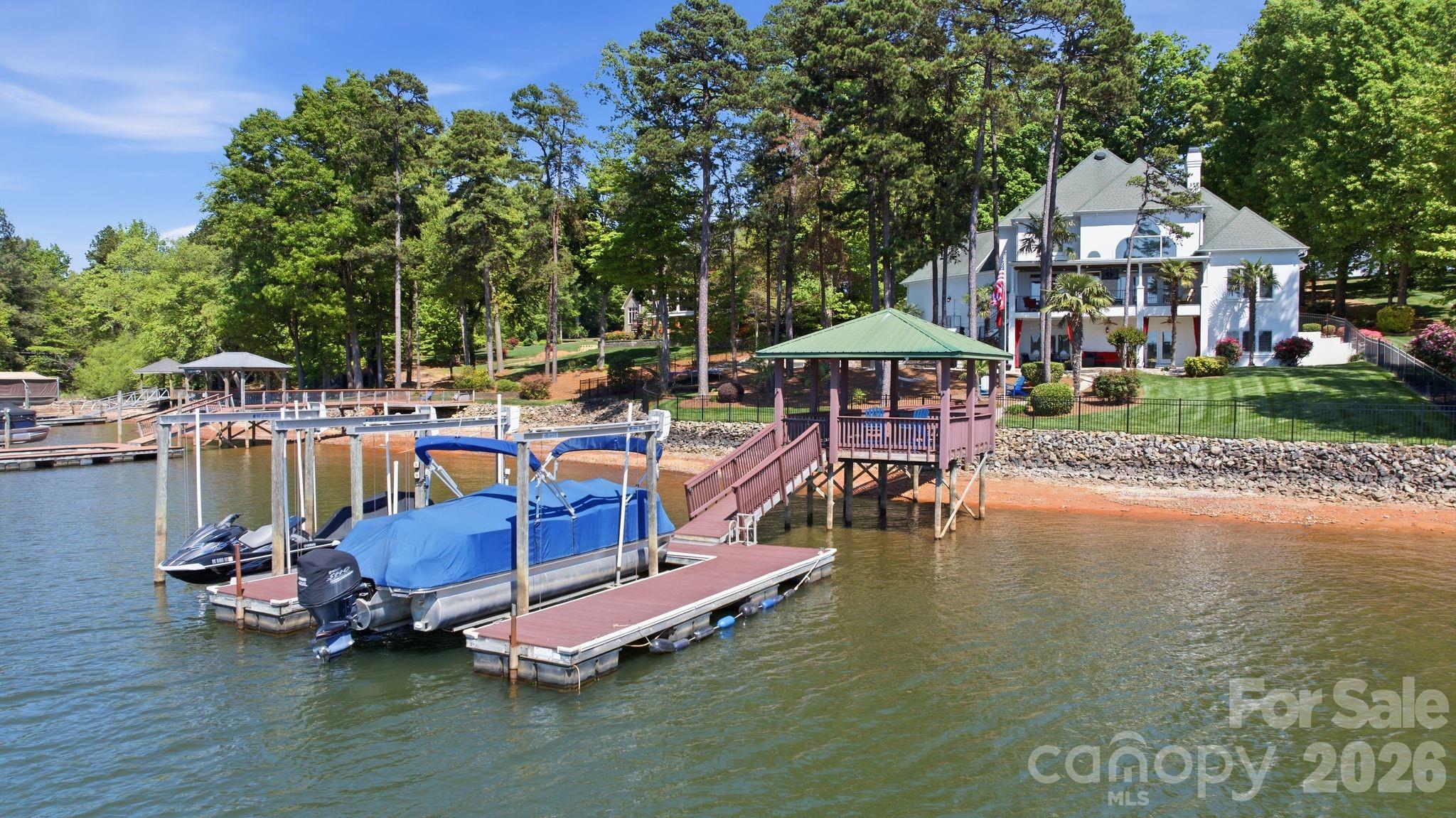 Dock with covered lounge area and two boat lifts. - 144 Mariner Pointe Lane, Mooresville