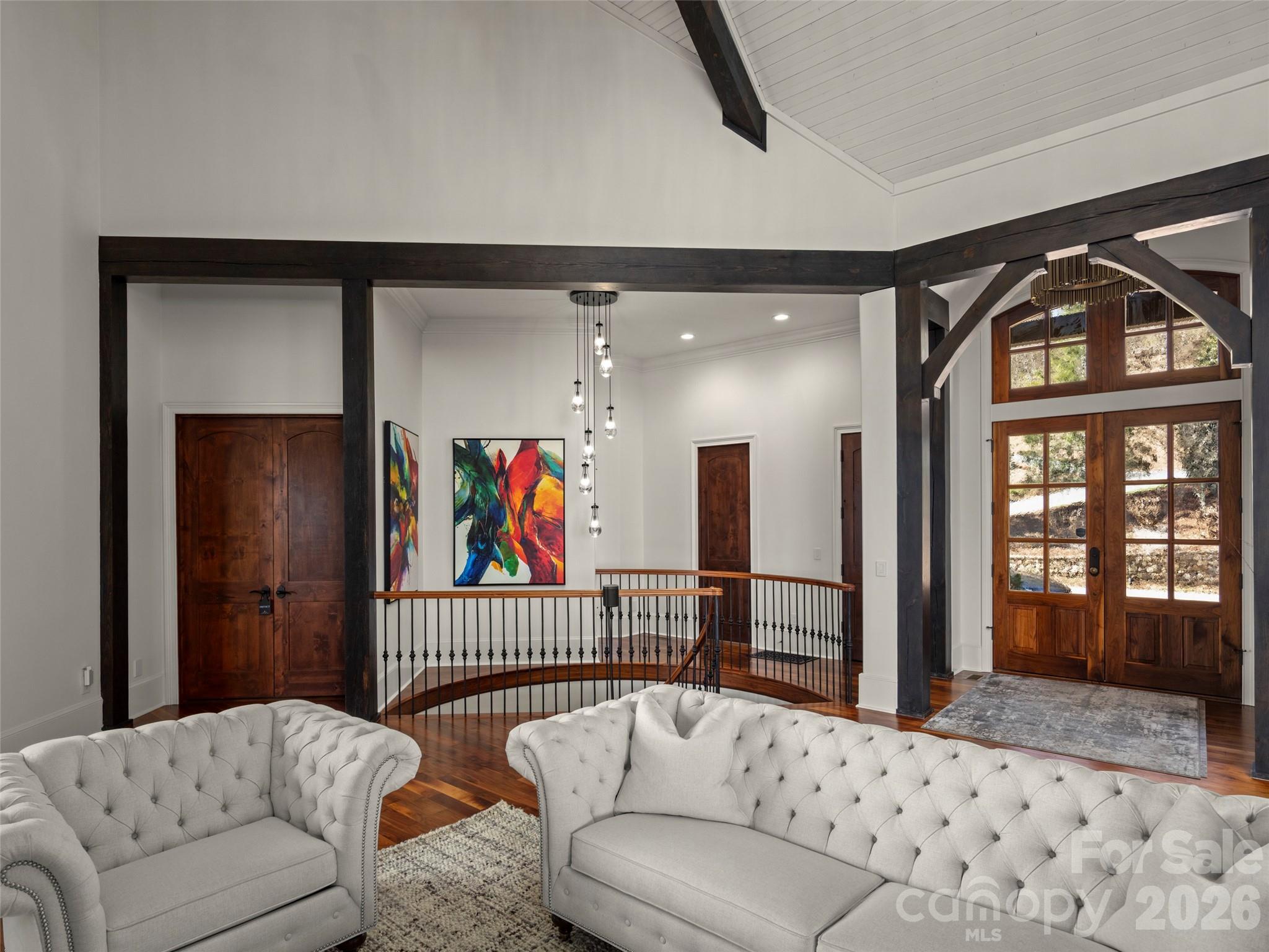grand room looking towards the front door and spiral stairs - 47 Ridge Pine Trail, Arden