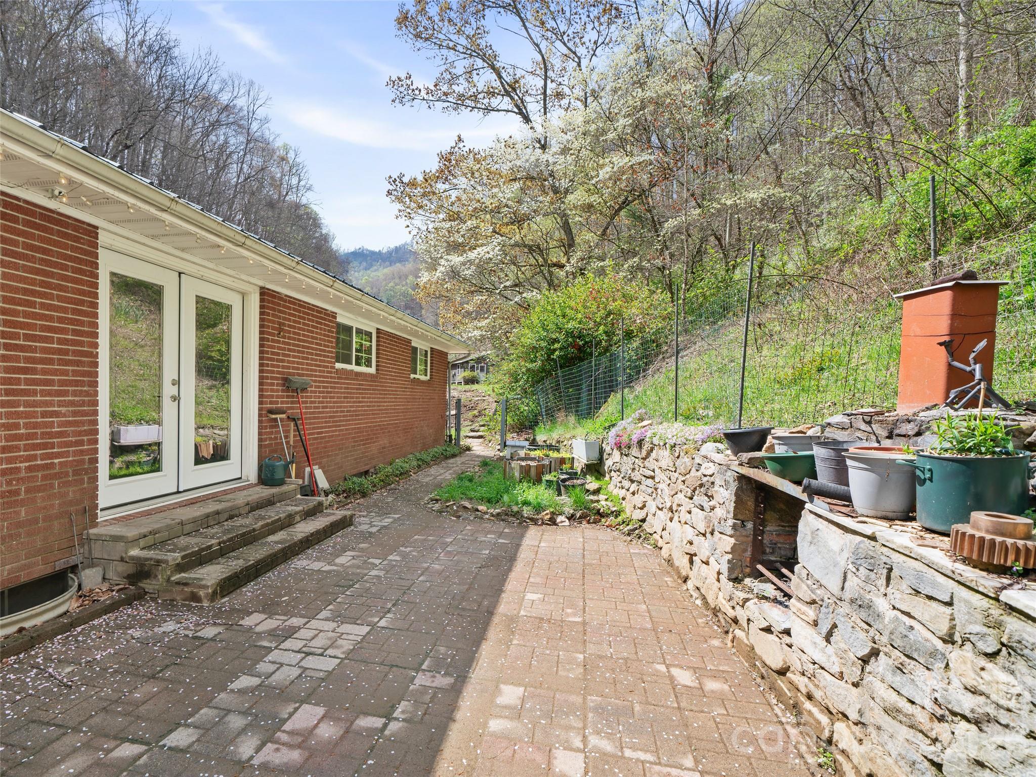 Spacious Patio---back of house with stone patio and outdoor built in grill - 3829 Coxes Creek Road, Burnsville