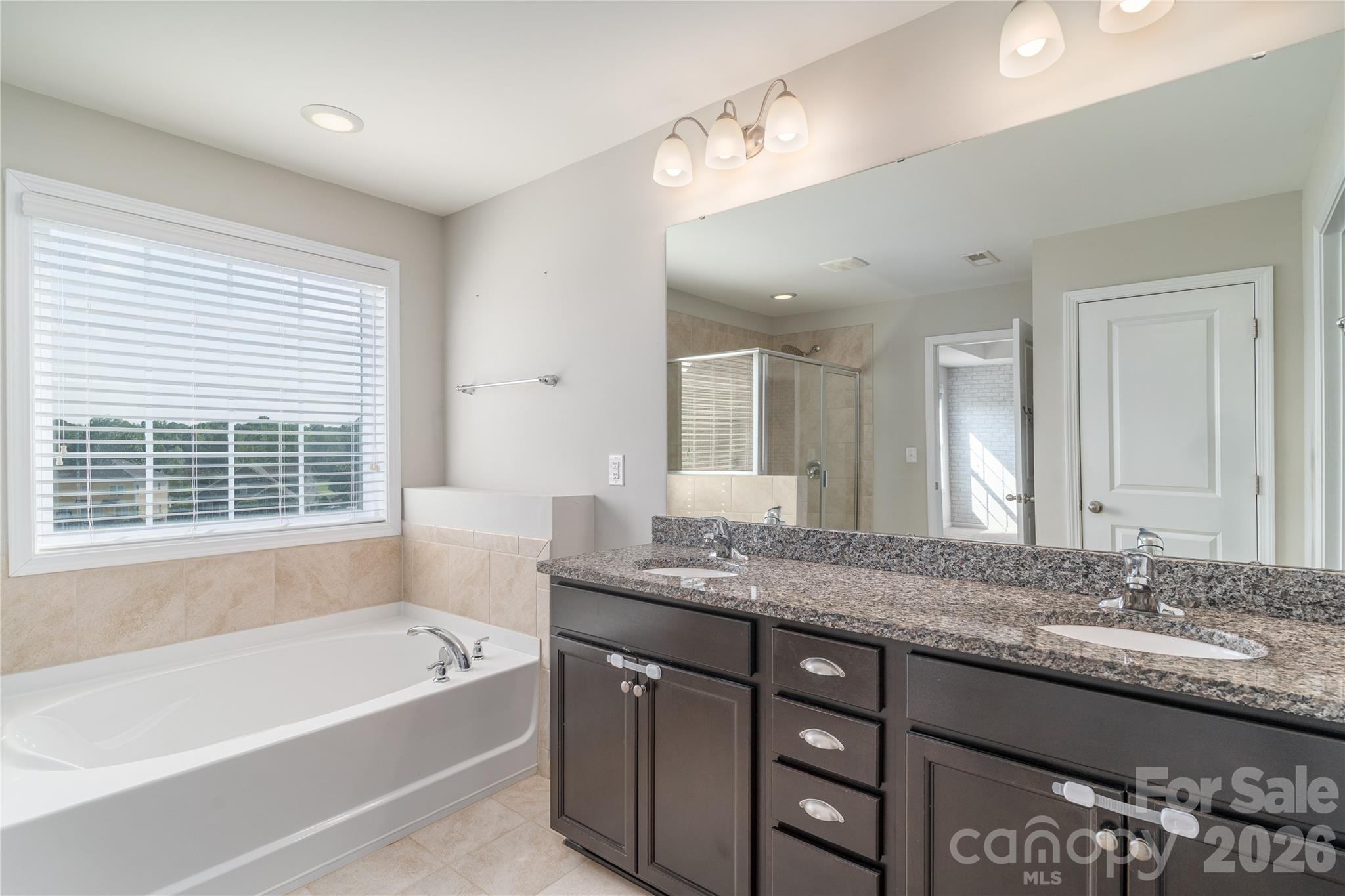 Dual granite vanity in the primary bathroom - 118 Margo Lane, Statesville