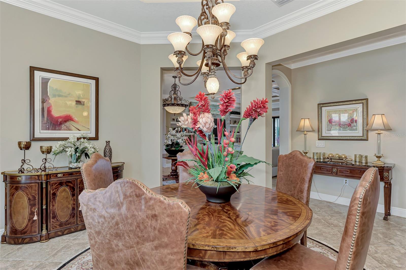 The dining room features plantation shutters, double crown molding, and large open dining. - 10965 BULLRUSH DR, VENICE